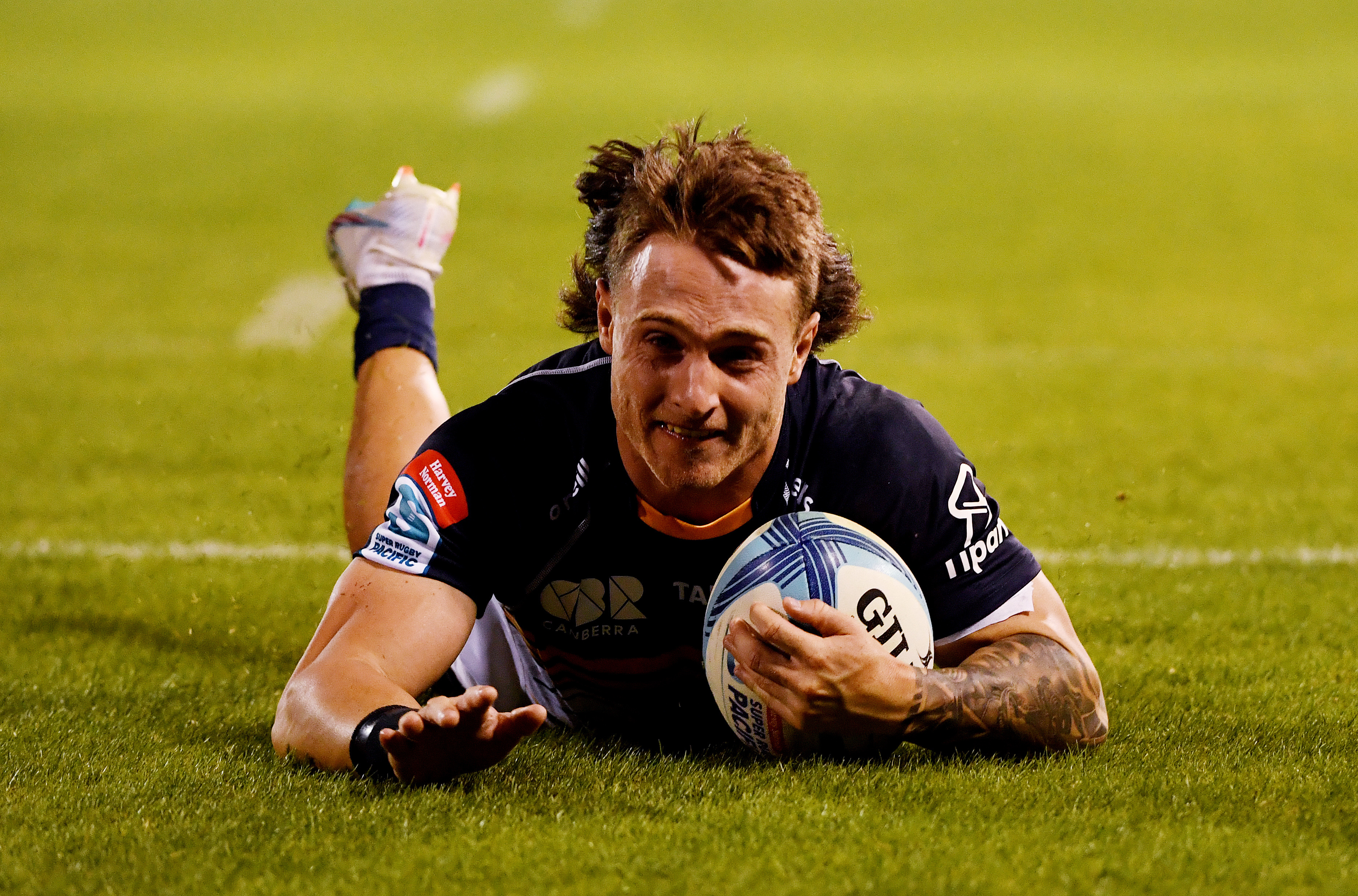 Corey Toole of the Brumbies scores a try.