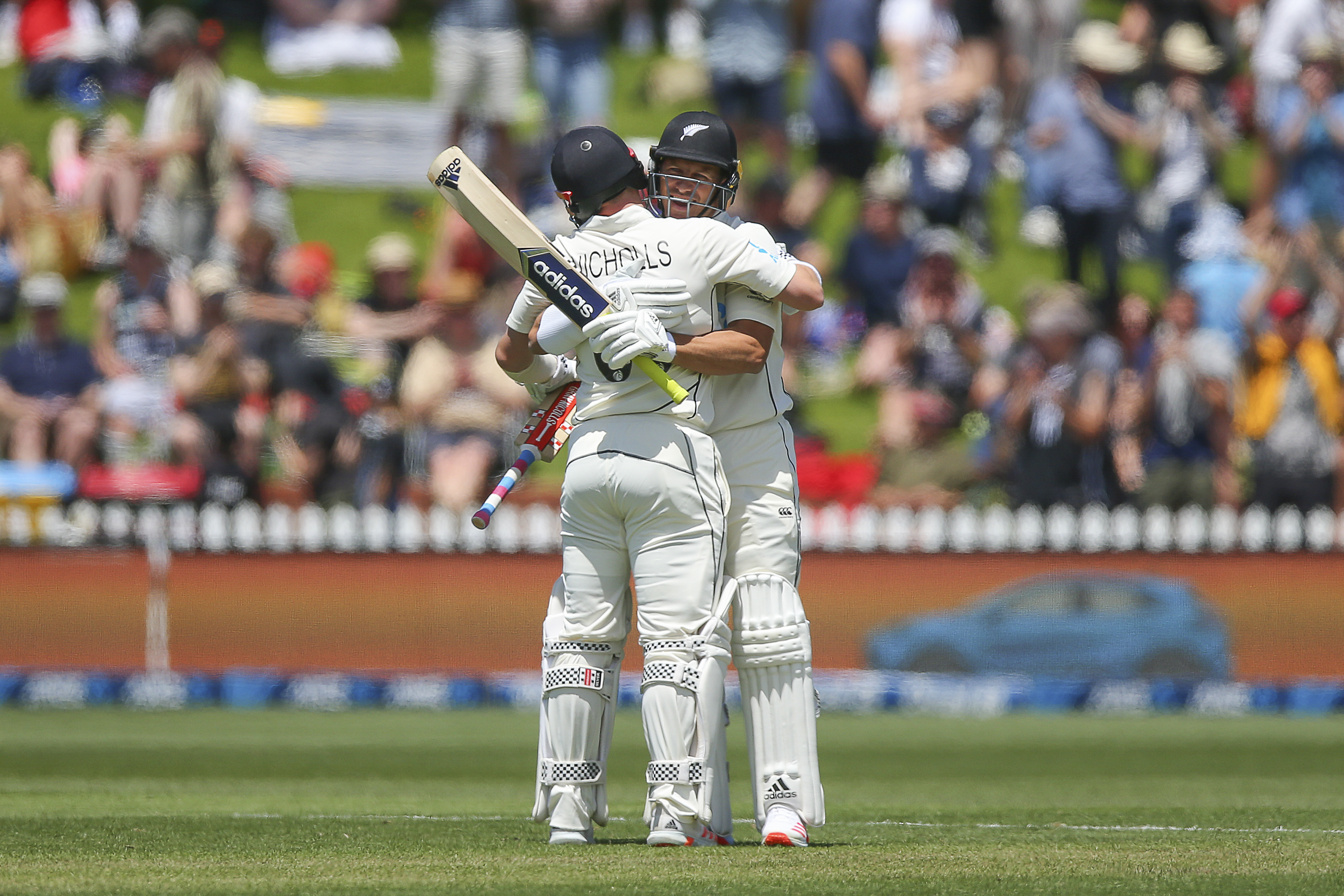 Neil Wagner of New Zealand celebrates his half century with teammate Henry Nicholls.