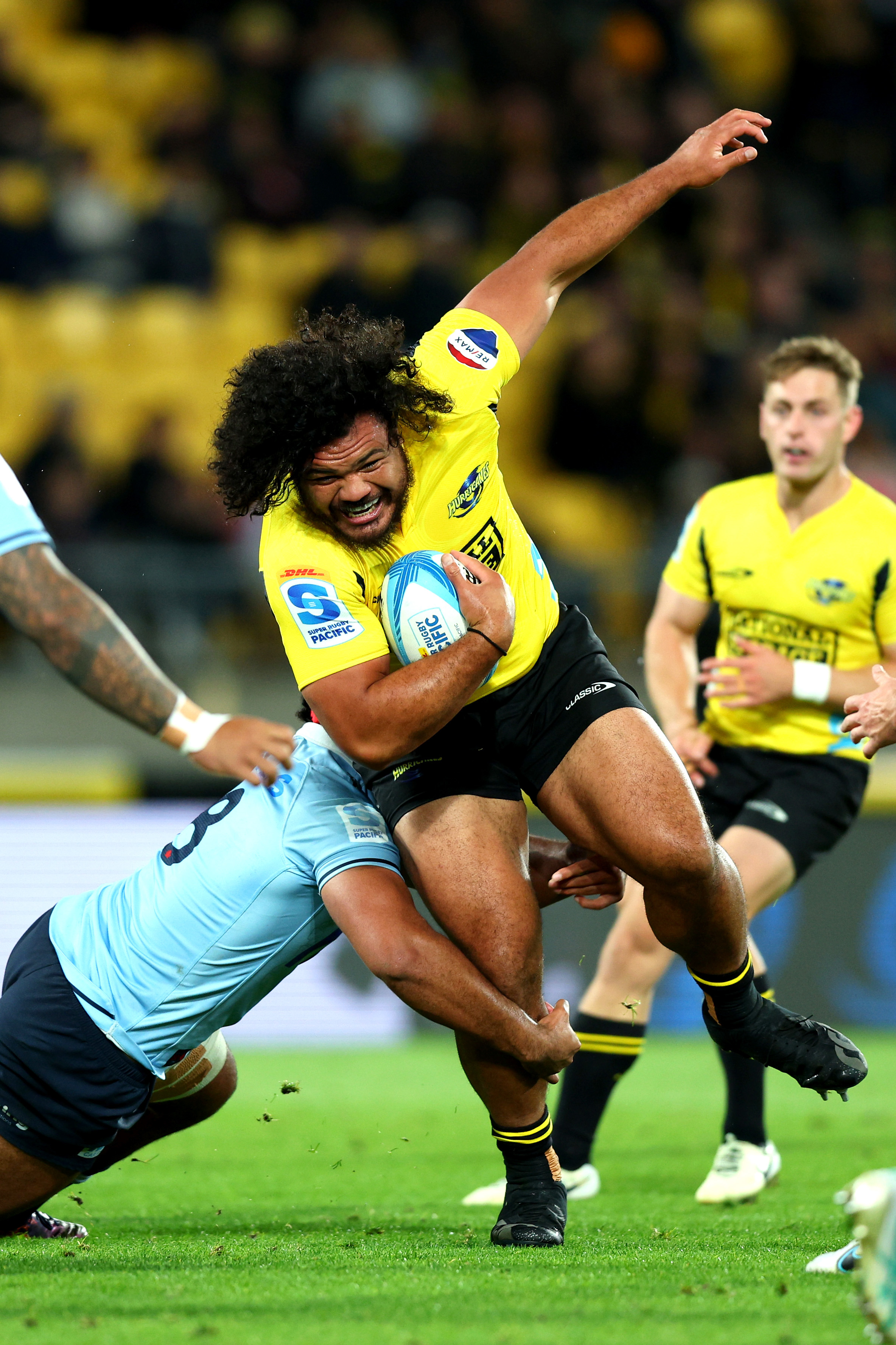 Pasilio Tosi of the Hurricanes is tackled at Sky Stadium.