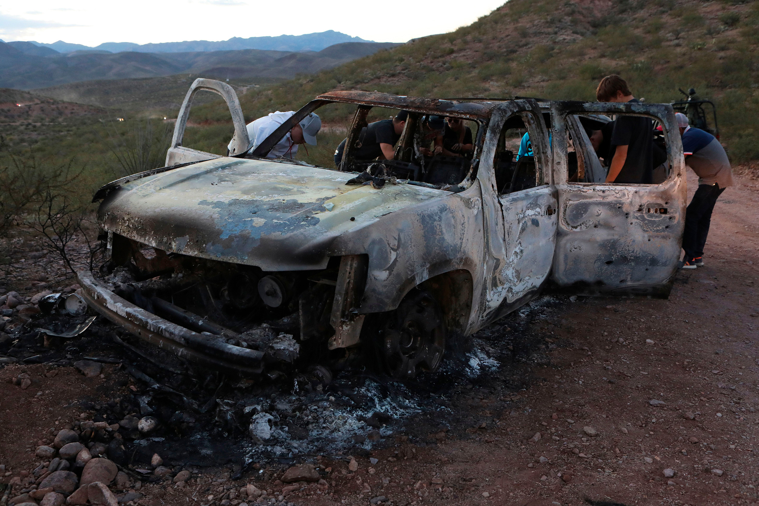 A man has been arrested in connection with last year's massacre of nine Mormon American-Mexican citizens on a remote dirt road in northwestern Mexico. In this photo, relatives of the slain examine one of the three vehicles that were attacked in Mexico's Sonora state.