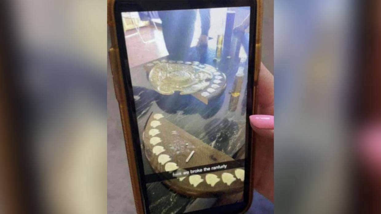 The damaged Ranfurly Shield with white powder on its surface.