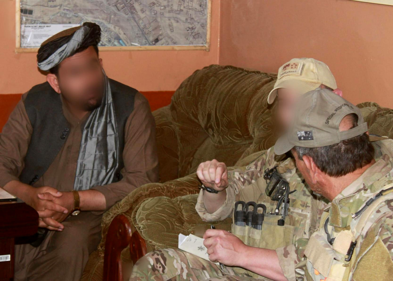 Former ADF soldier Shane Healy (middle) meets with a local Afghan on a 2012 mission in Uruzgan province.
