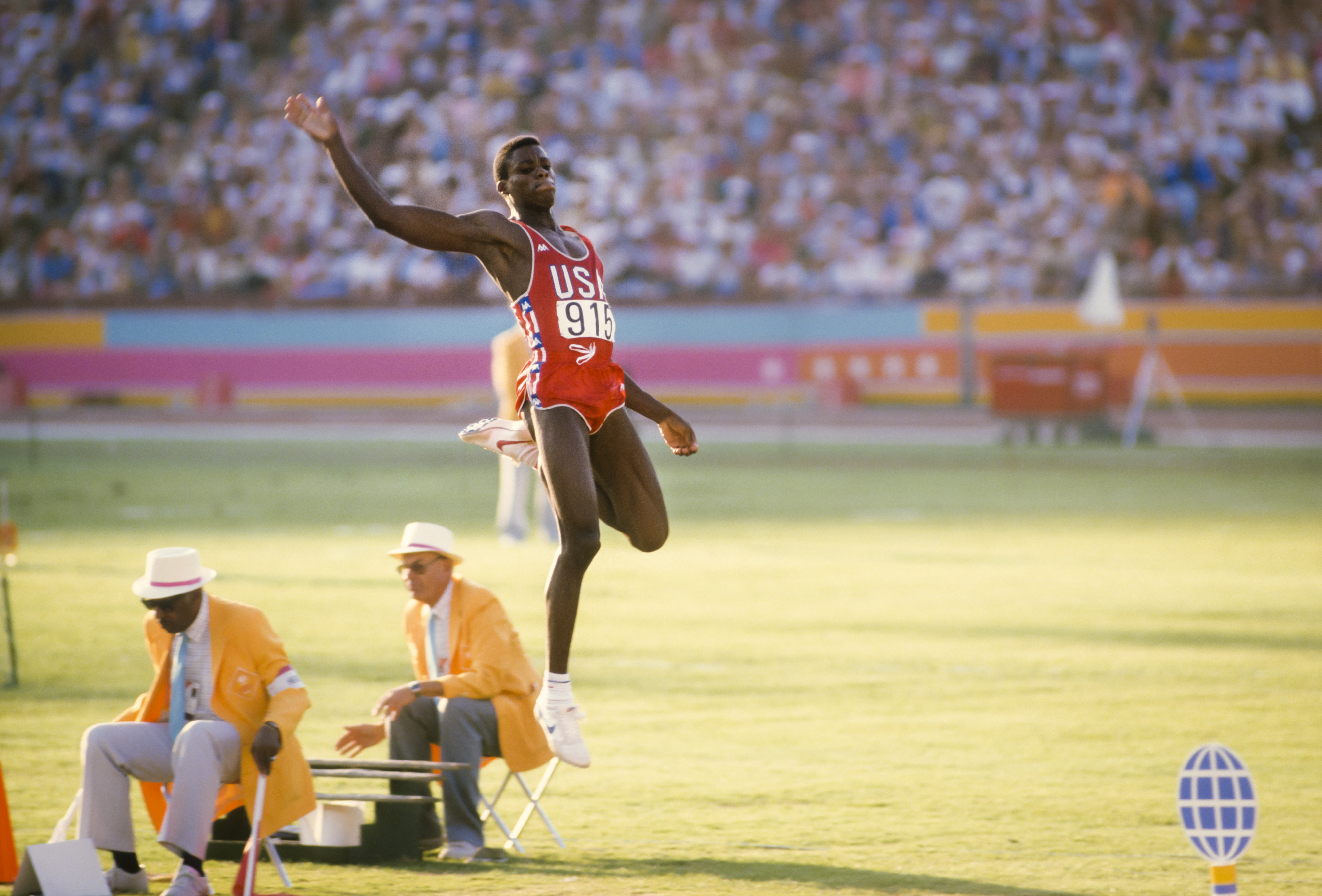 Carl Lewis launches into the long jump pit at the Los Angeles 1984 Olympics.