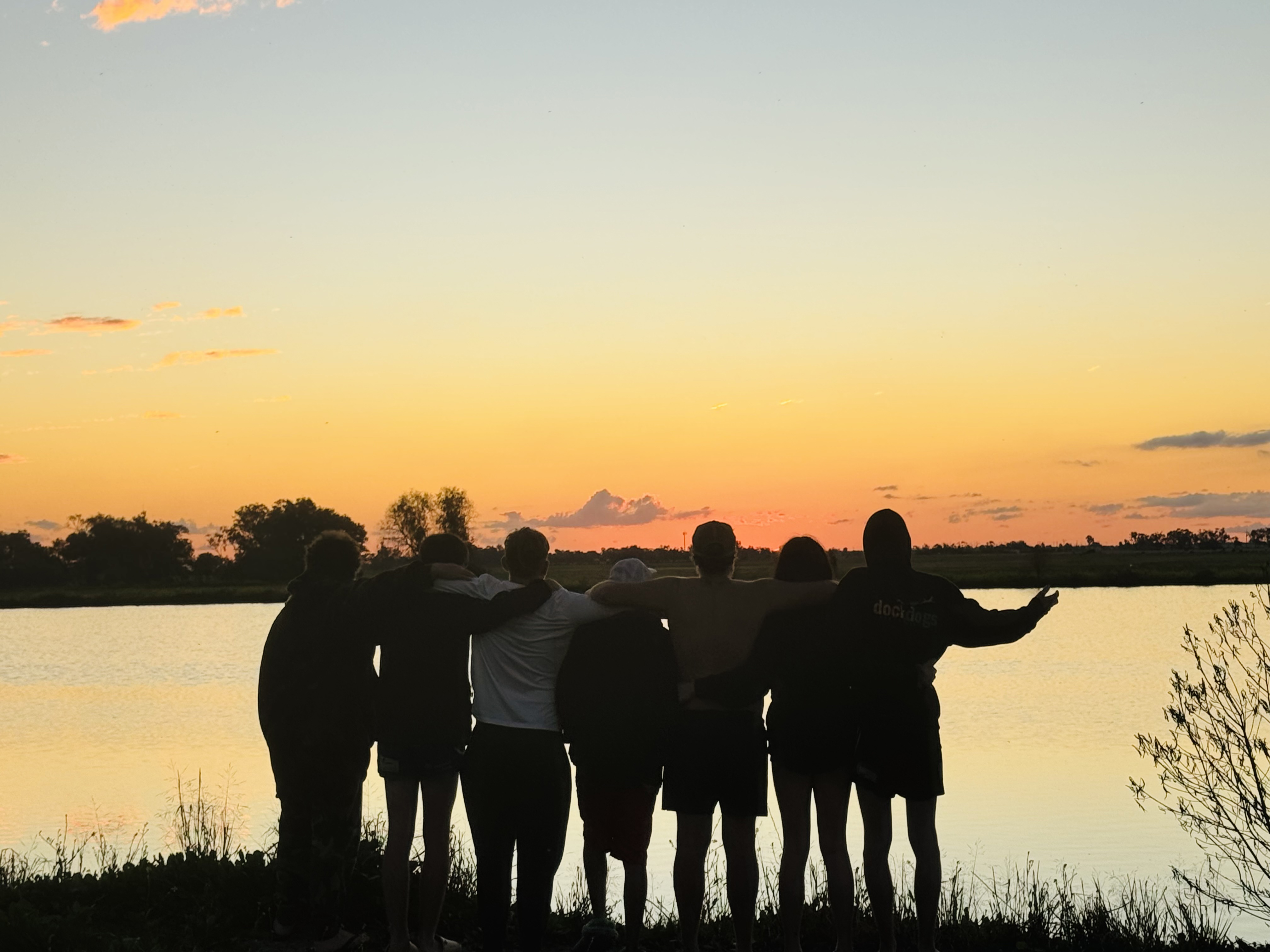 BackTrack participants watch a sunset over a lake.