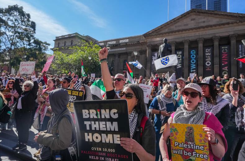 Pro-Palestine protesters chant outside the State Library of Victoria on August 03, 2025 in Melbourne, Australia. Protesters in Sydney and Melbourne joined marches and actions globally, as pressure mounts on the Israeli government over a devastating humanitarian crisis unfolding as its war against Hamas continues. (Photo by Asanka Ratnayake/Getty Images)