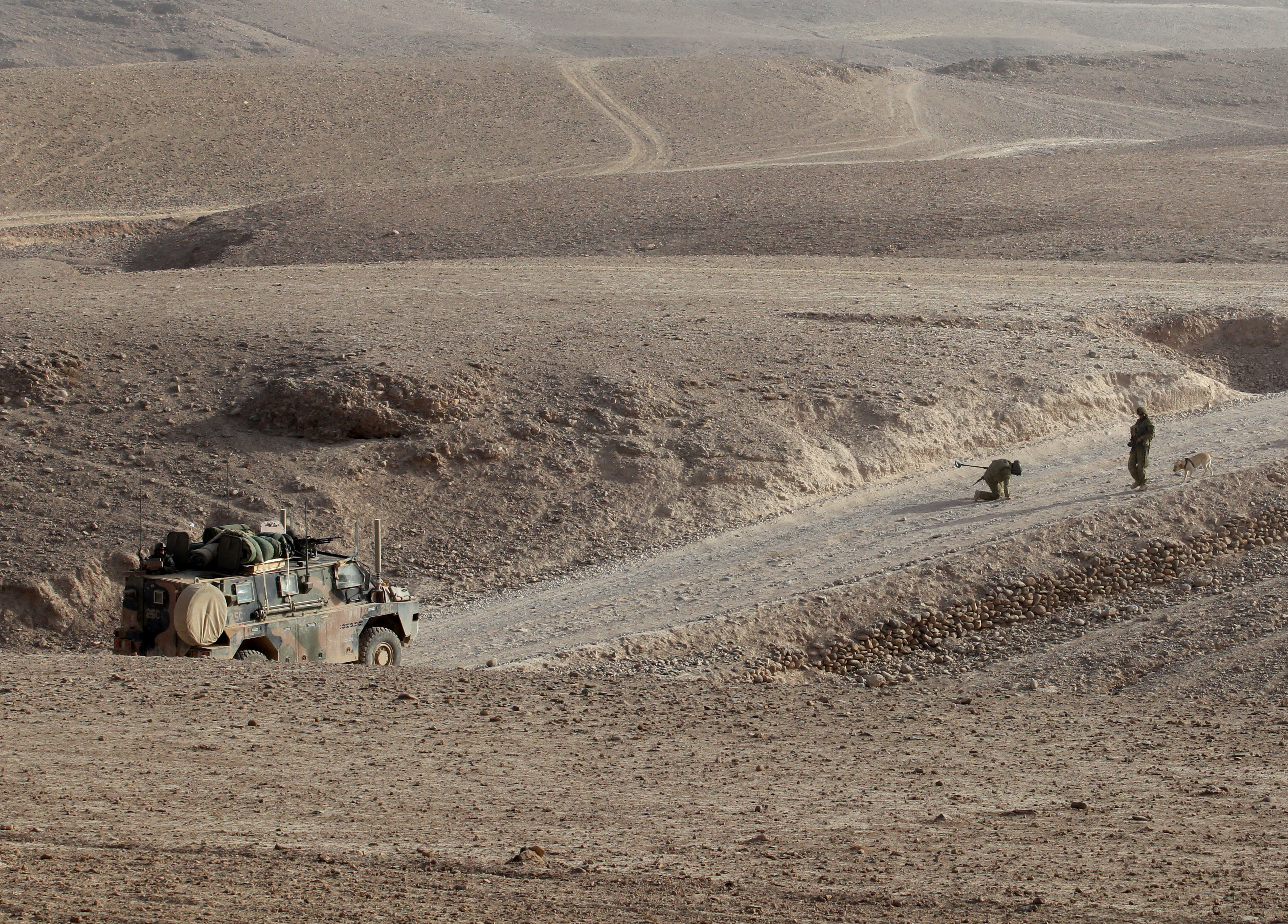 Australian soldiers check for improvised explosive devices whilst convoying in the Bushmaster vehicles from Tarin Kowt to the Miribad Valley in Uruzgan Province, Afghanistan.