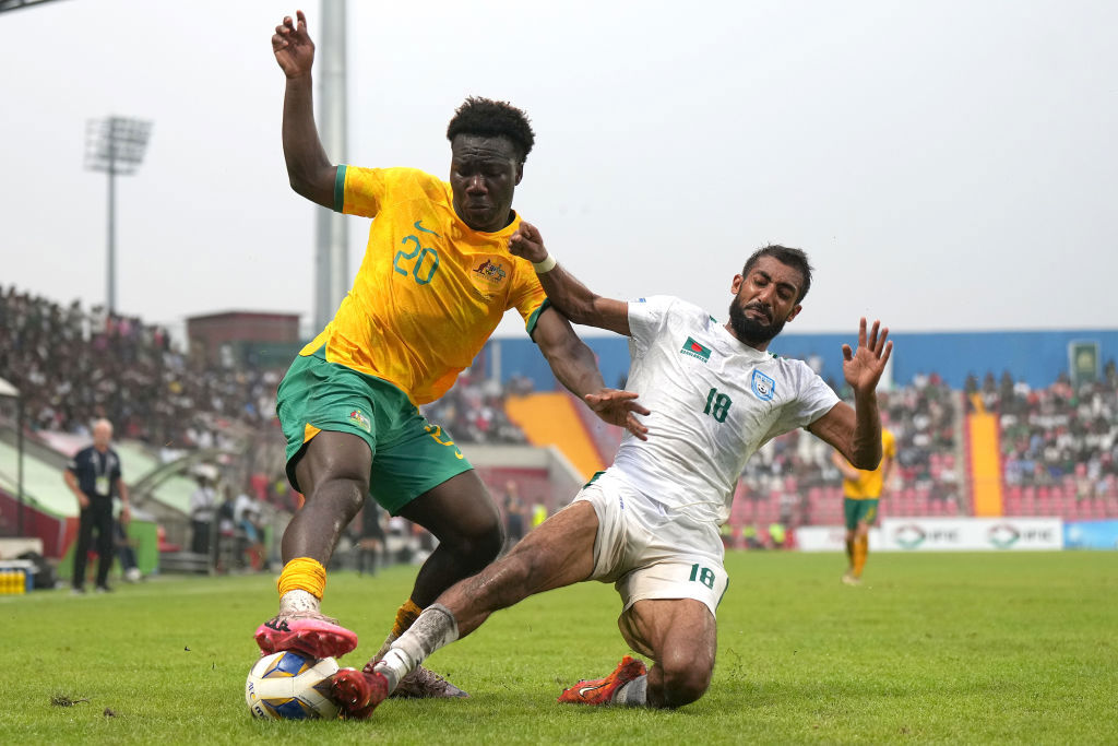 Nestory Irankunda is tackled by Isa Faysal of Bangladesh during the FIFA World Cup Asian second qualifier Group I match.