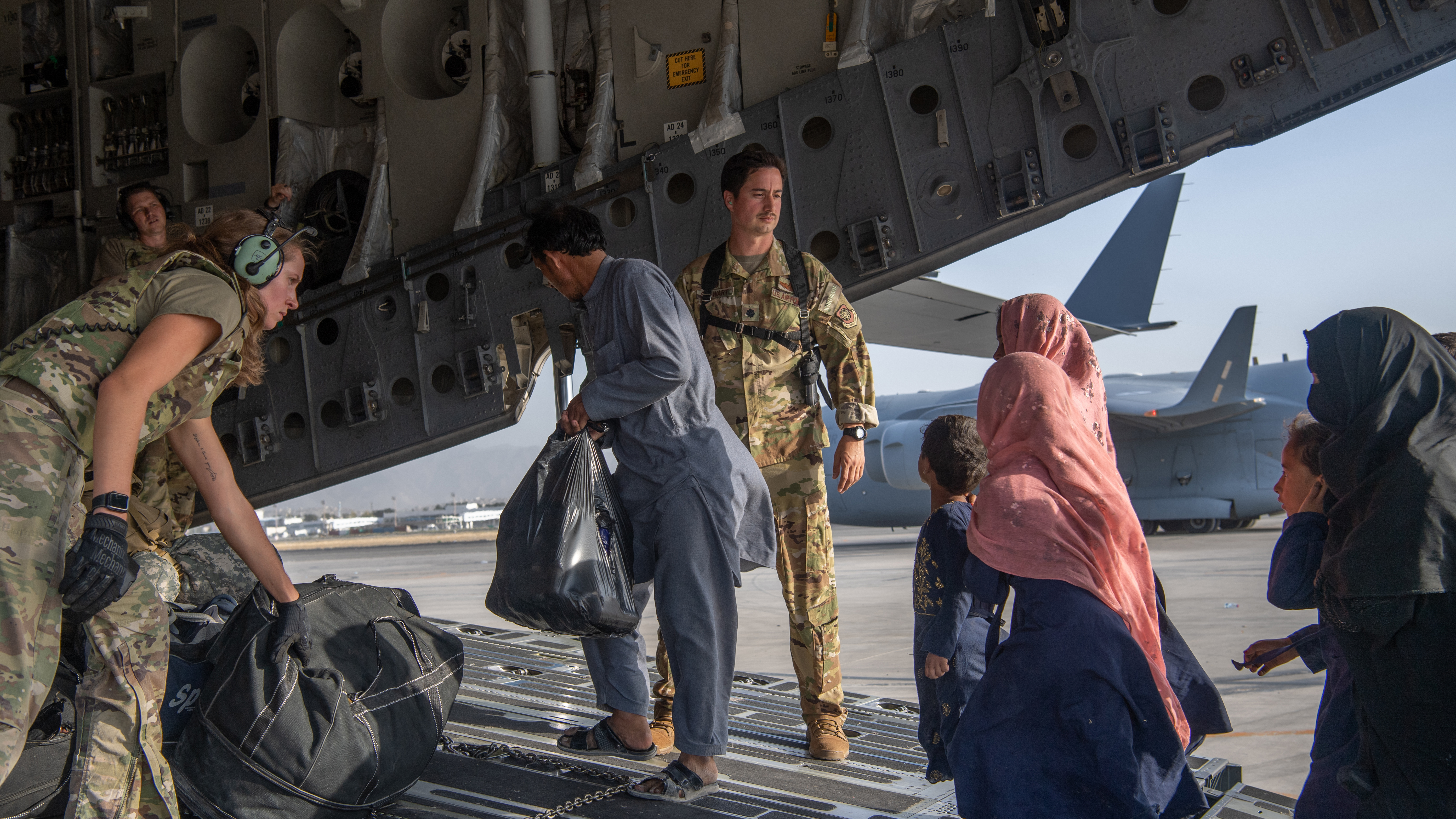 US troops load passengers aboard a US Air Force C-17 Globemaster III in support of the Afghanistan evacuation at Hamid Karzai International Airport (HKIA) on August 24.
