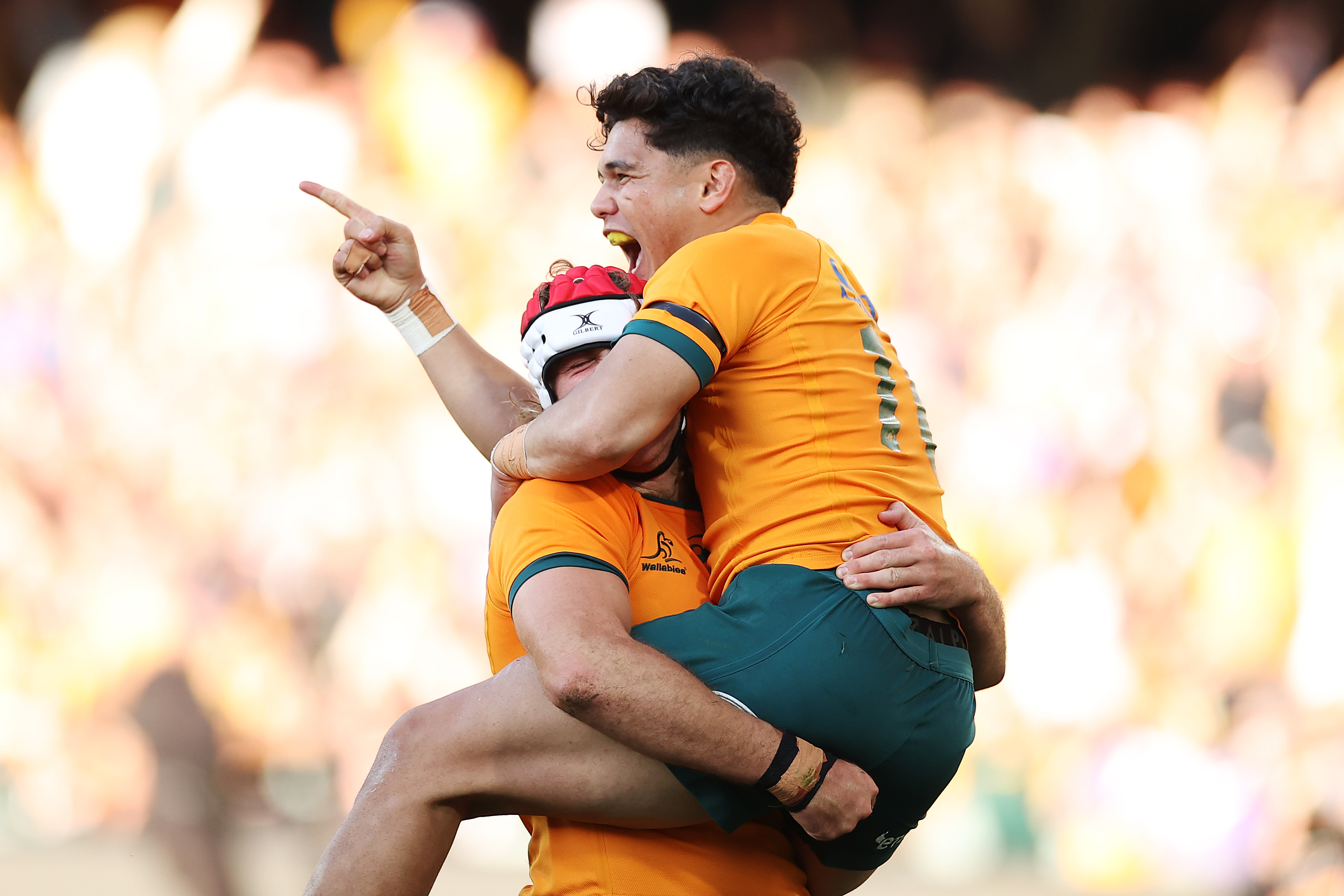 Noah Lolesio of the Wallabies celebrates with try-scorer Fraser McReight.