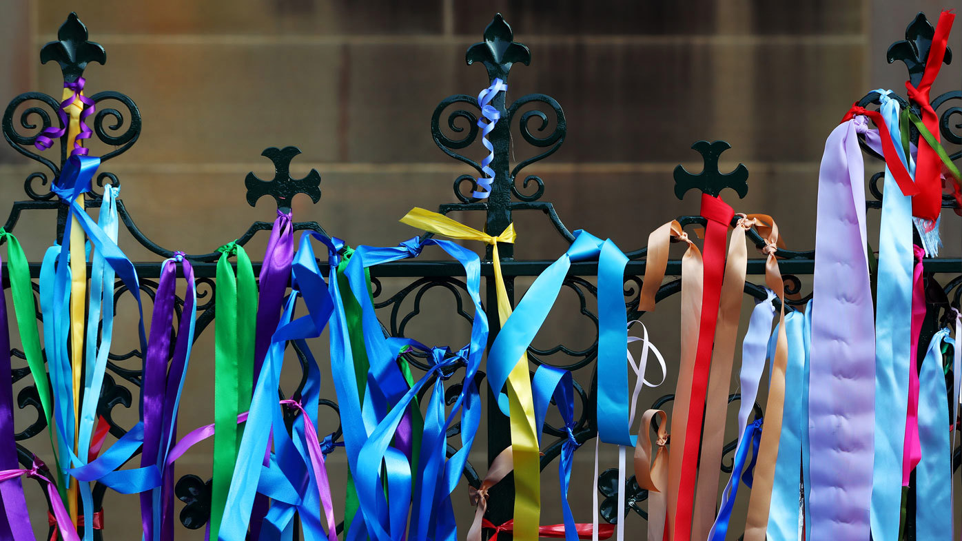 Rainbow ribbons attached to the gates outside the church.