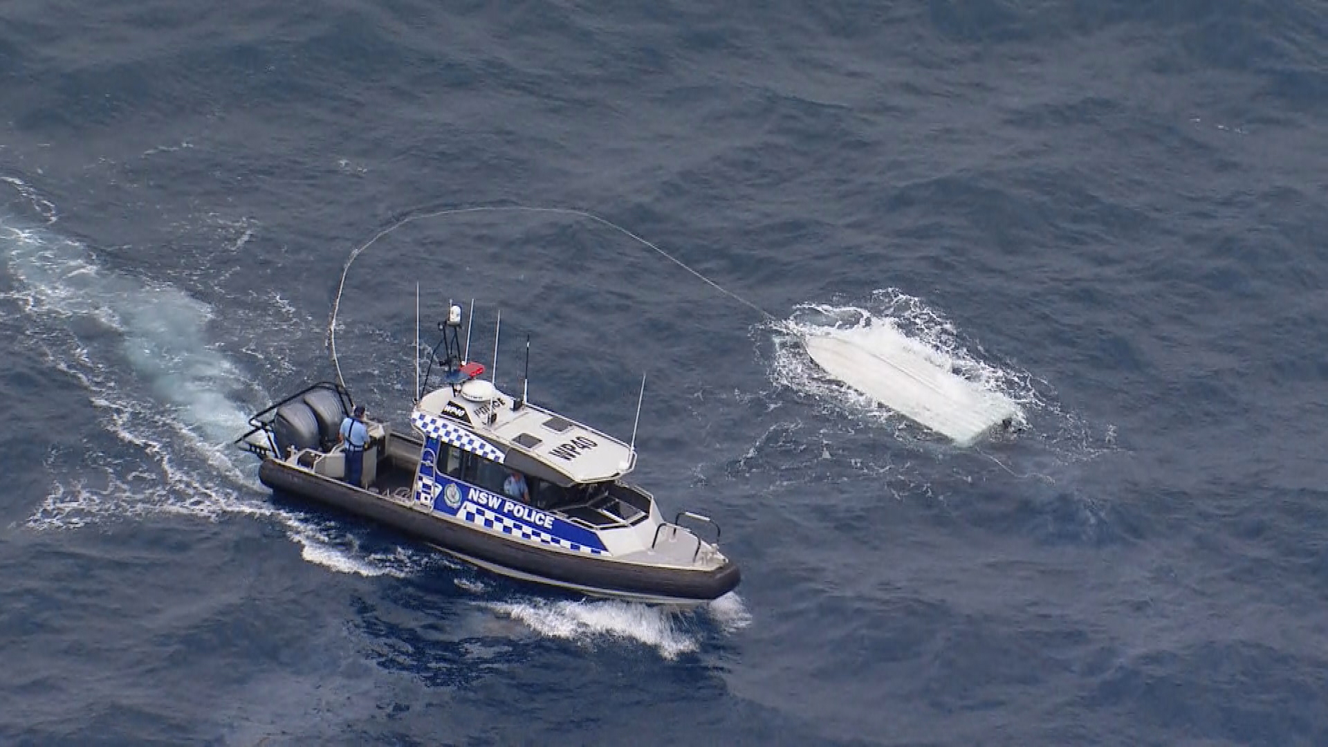 Three men have been rescued by three helicopters after a freak wave threw them overboard
