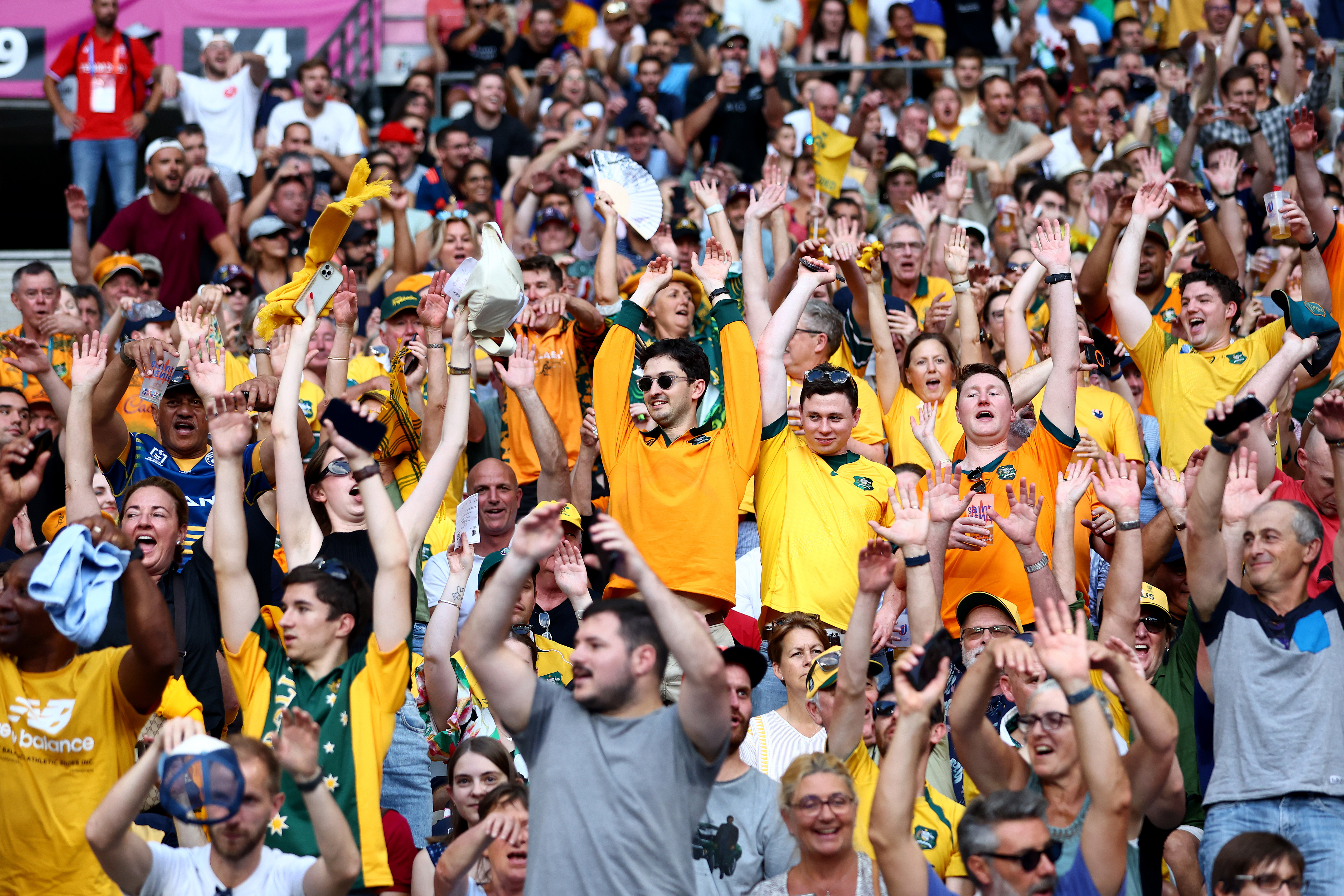 Fans of Australia take part in a Mexican wave at Stade de France.