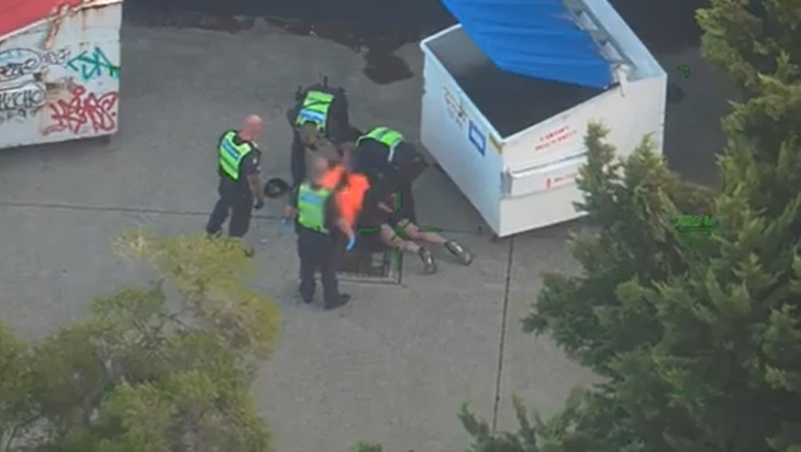 The man jumped out of the rubbish bin, where he was arrested by police.