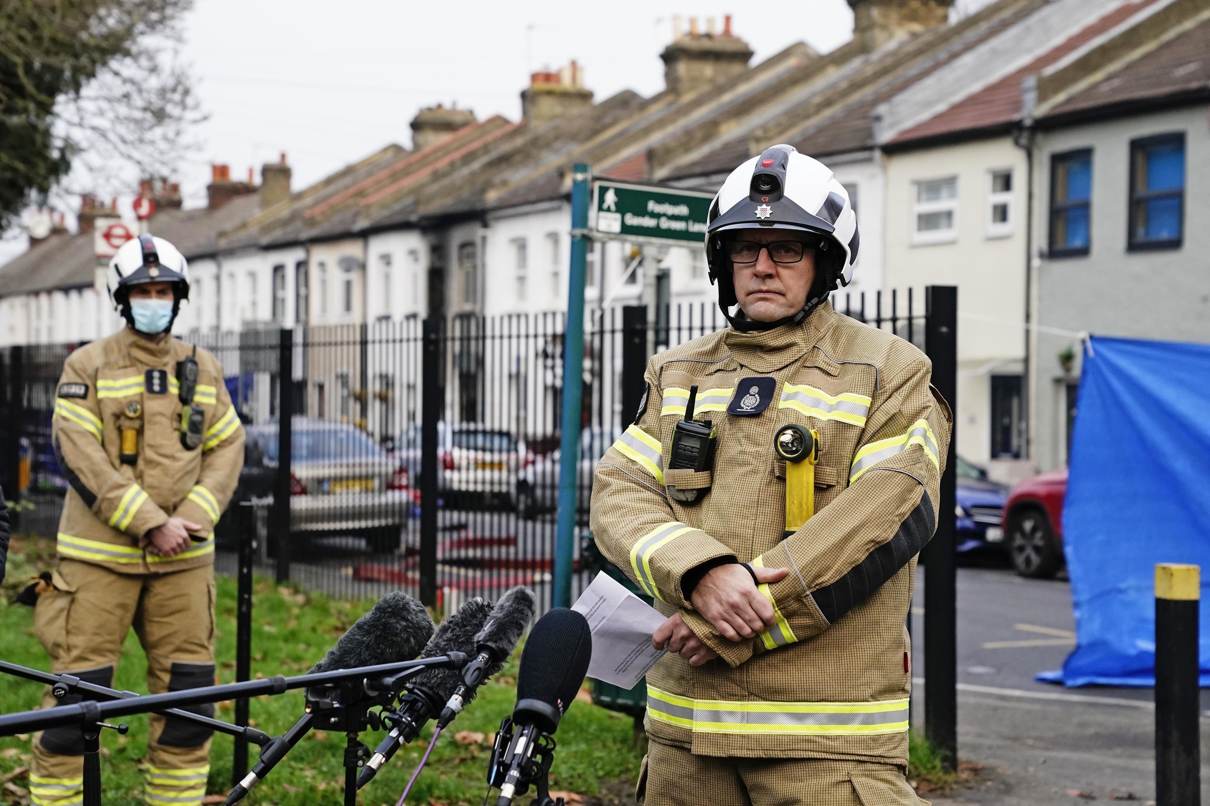 Firefighters at the scene in Sutton, south London, where four children have died following a fire at a house. Picture date: Thursday December 16, 2021. PA Photo. See PA story FIRE Sutton. Photo credit should read: Kirsty O'Connor/PA Wire