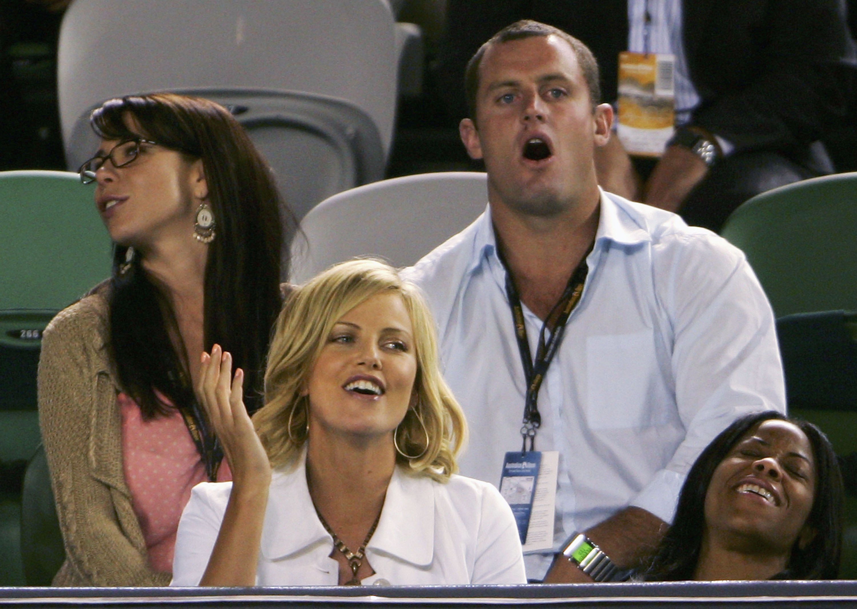 Kate Ritchie, Chris Walker and Charlize Theron during the Quarter-Final match between Justine Henin-Hardenne and Lindsay Davenport during day nine of the Australian Open at Melbourne Park January 24, 2006 in Melbourne, Australia.