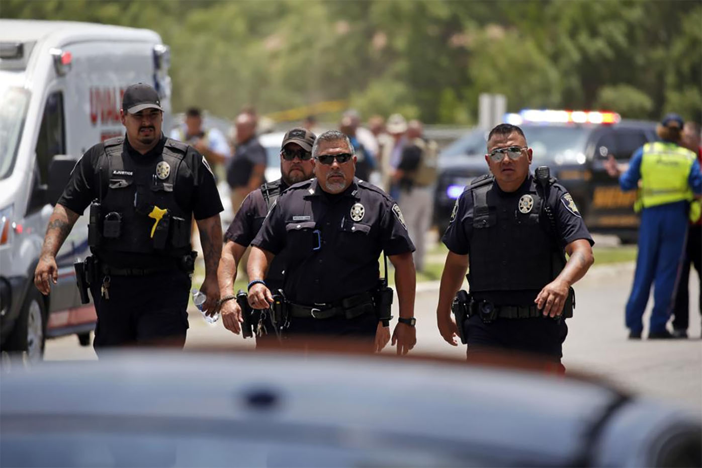 Police walk near Robb Elementary School following a shooting, Tuesday, May 24, 2022, in Uvalde, Texas.