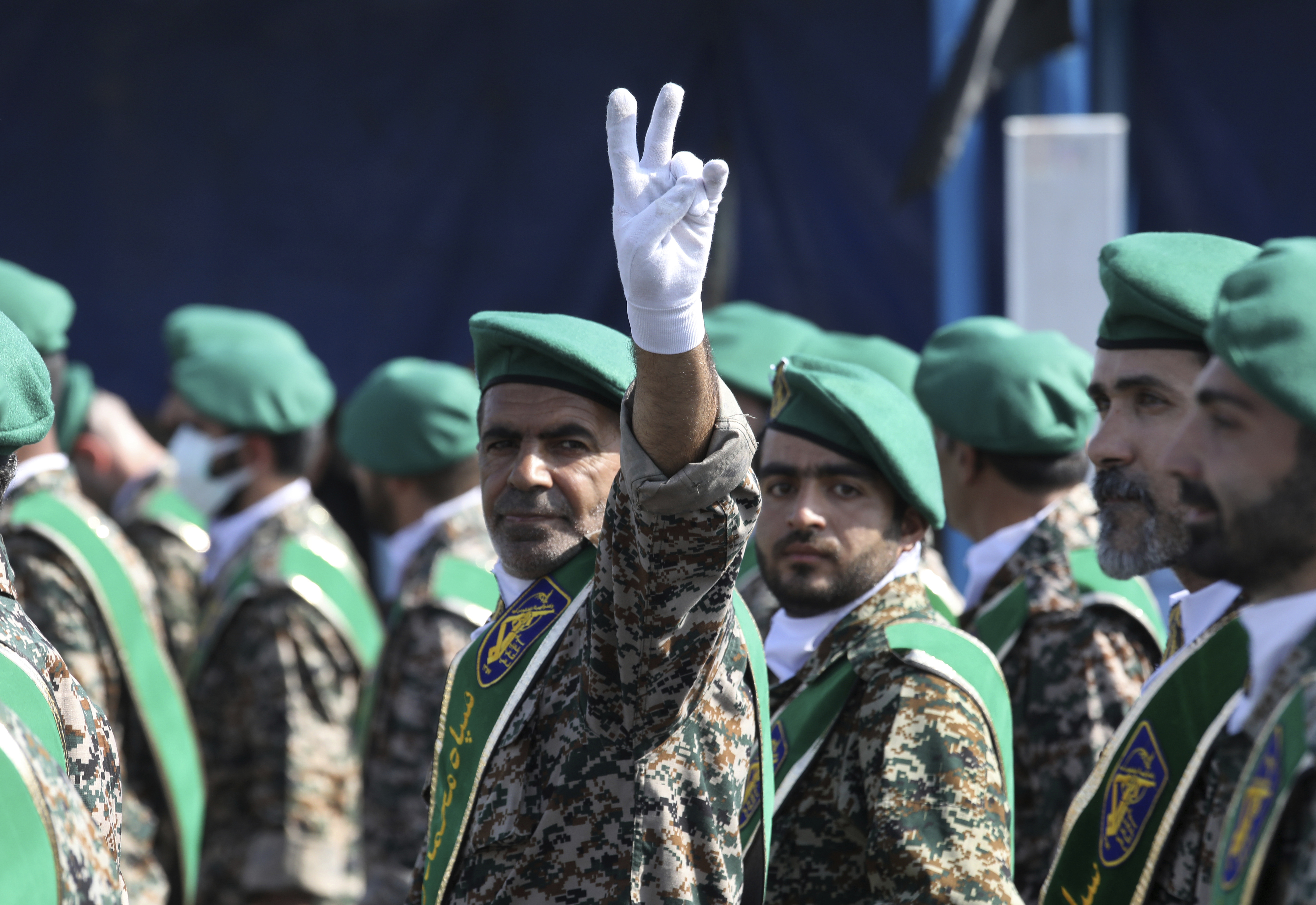 A member of Iran's Basij paramilitary force, affiliated to the Revolutionary Guard, flashes a victory sign during a military parade commemorating the anniversary of start of the 1980-88 Iraq-Iran war, in front of the shrine of the late revolutionary founder Ayatollah Khomeini, just outside Tehran, Iran, Thursday, Sept. 22, 2022.