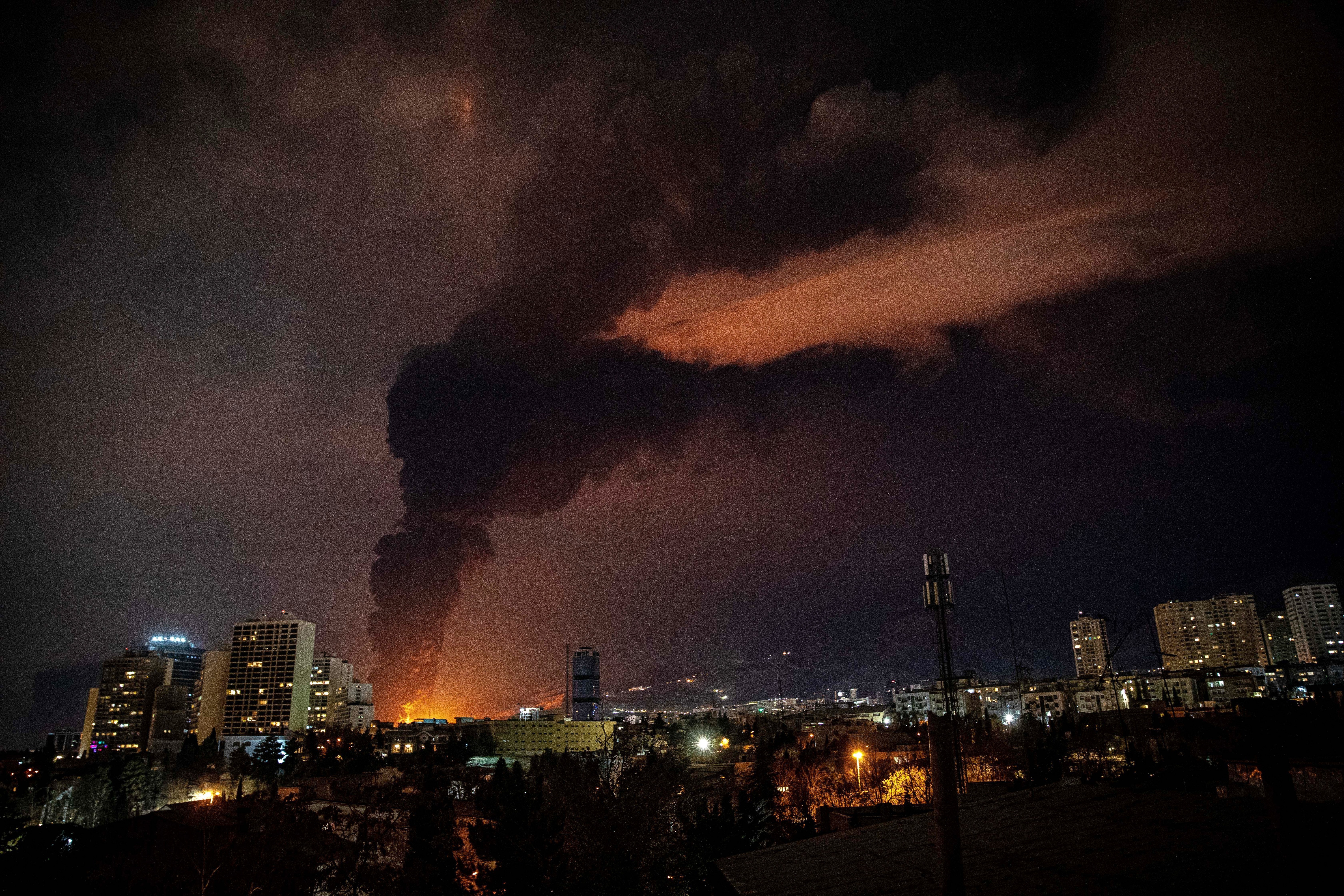 Flames and smoke rise from an oil storage facility struck during the US-Israeli military campaign in Tehran, Iran,  