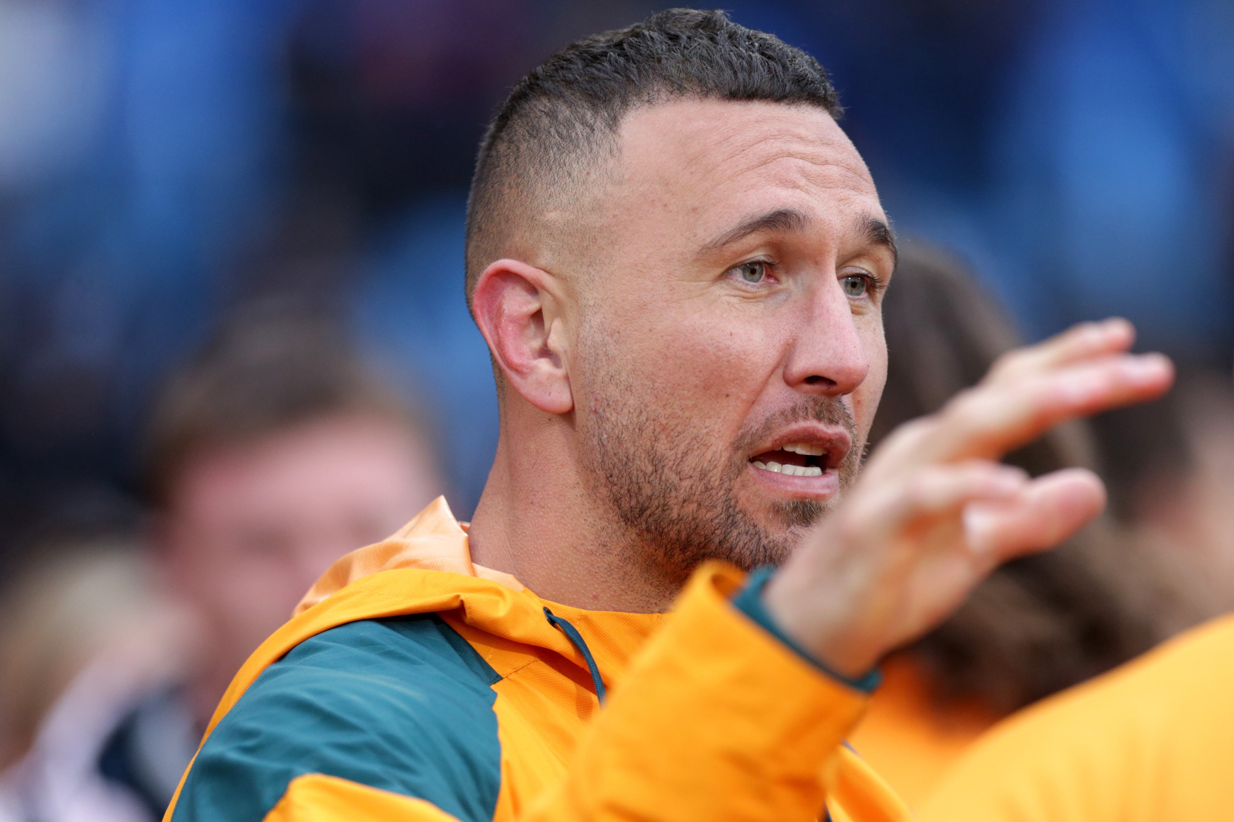 Quade Cooper talks to a teammate from the sidelines after his injury.