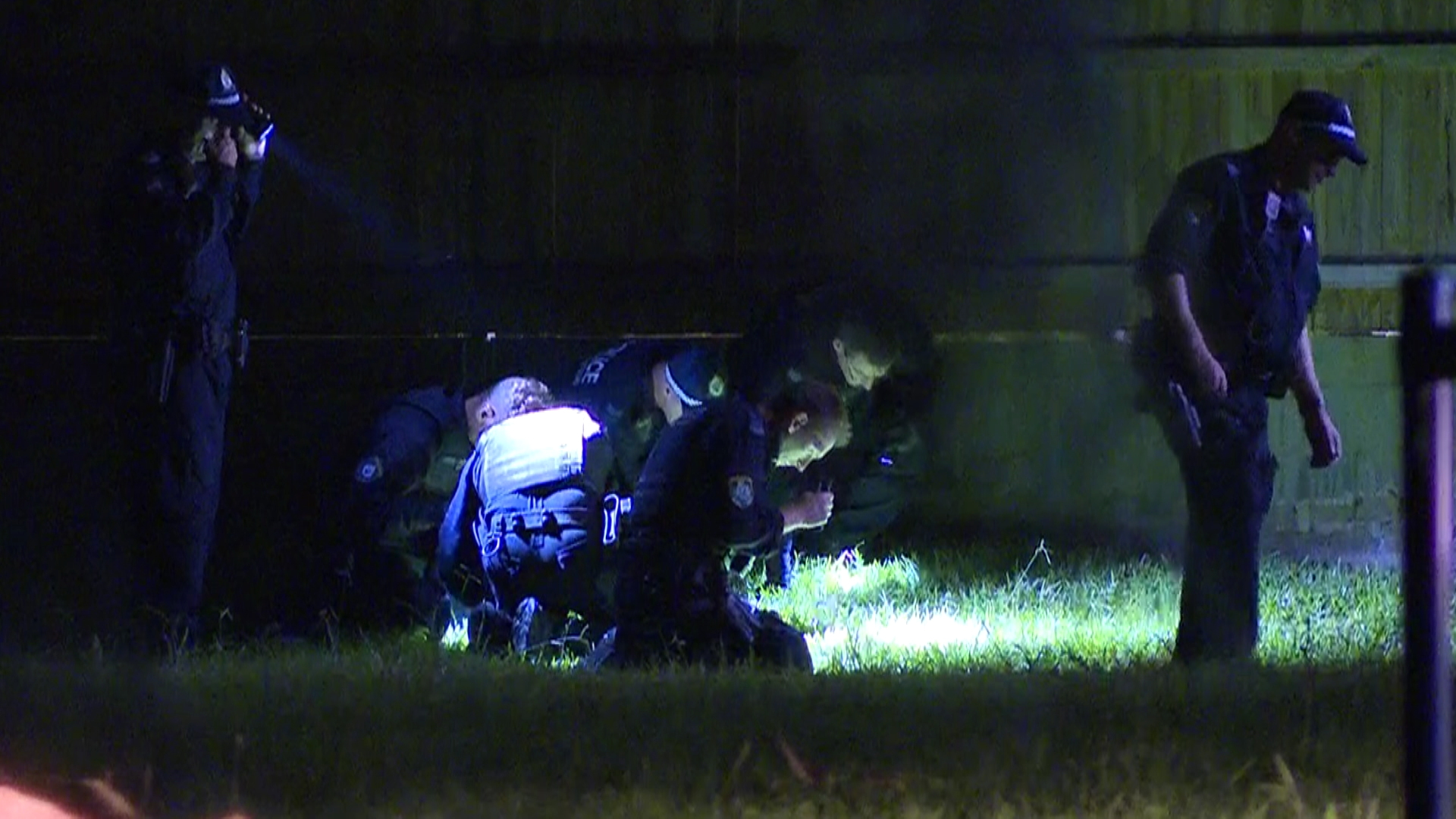 Officers search the scene for evidence.