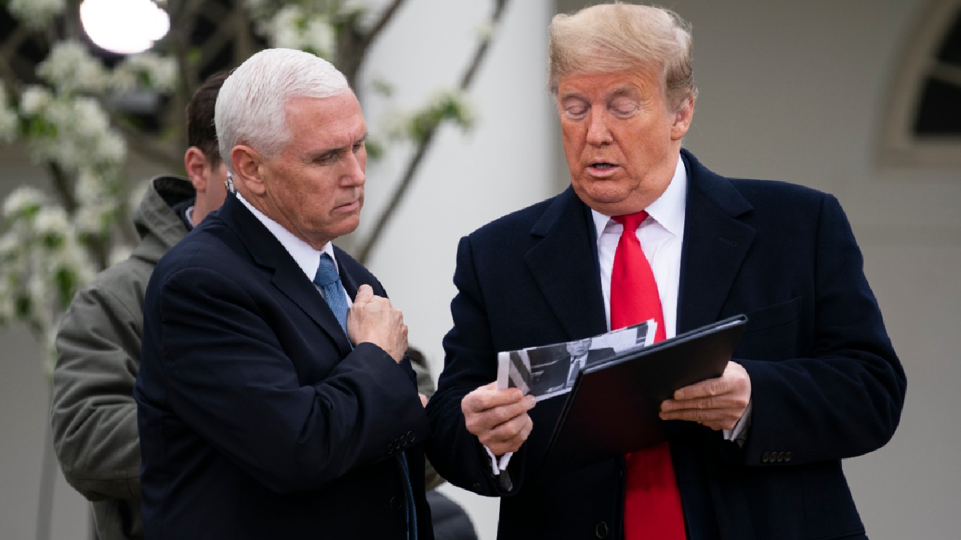 Mike Pence and Donald Trump look over their notes in the rose garden of the White House.