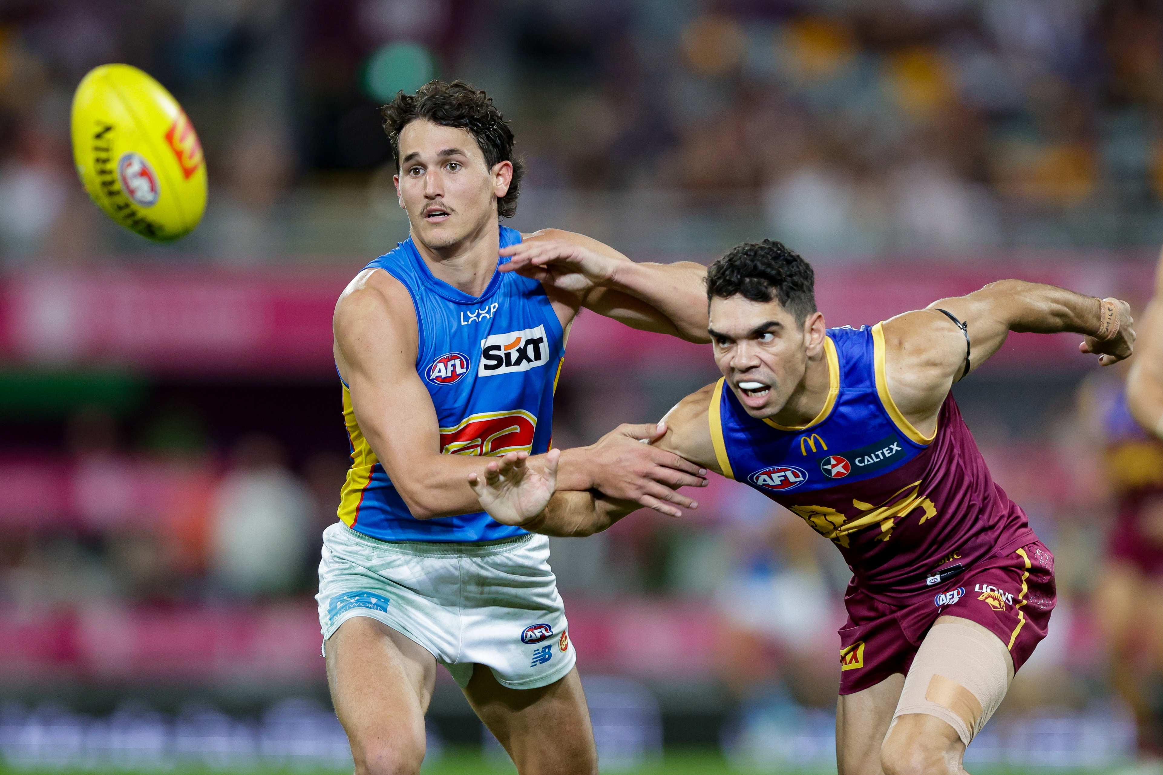 Wil Powell of the Suns and Charlie Cameron of the Lions in action during the 2024 AFL Round 08 match between the Brisbane Lions and the Gold Coast SUNS at The Gabba on May 05, 2024 in Brisbane, Australia. (Photo by Russell Freeman/AFL Photos via Getty Images)