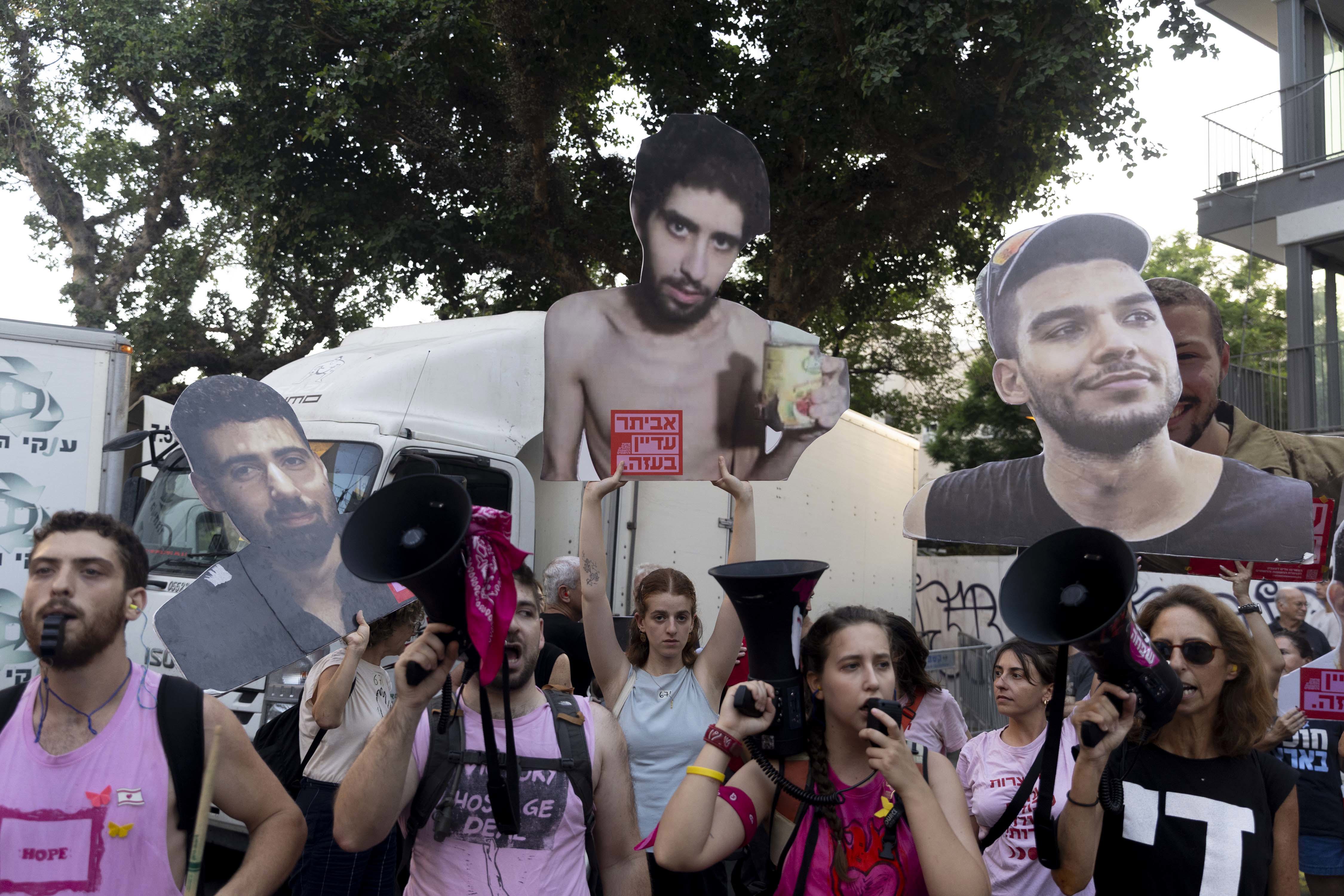 TEL AVIV, ISRAEL - AUGUST 7: Protesters hold photos of hostages held in the Gaza Strip during a protest calling for a hostages deal on August 7, 2025 in Tel Aviv, Israel. Local media reports that Israeli Prime Minister Benjamin Netanyahu is seeking backing from his security cabinet for the "full occupation" of the Gaza Strip, despite warnings from security officials and human rights groups that such a move could further endanger the lives of hostages still believed to be held alive by Hamas, as 