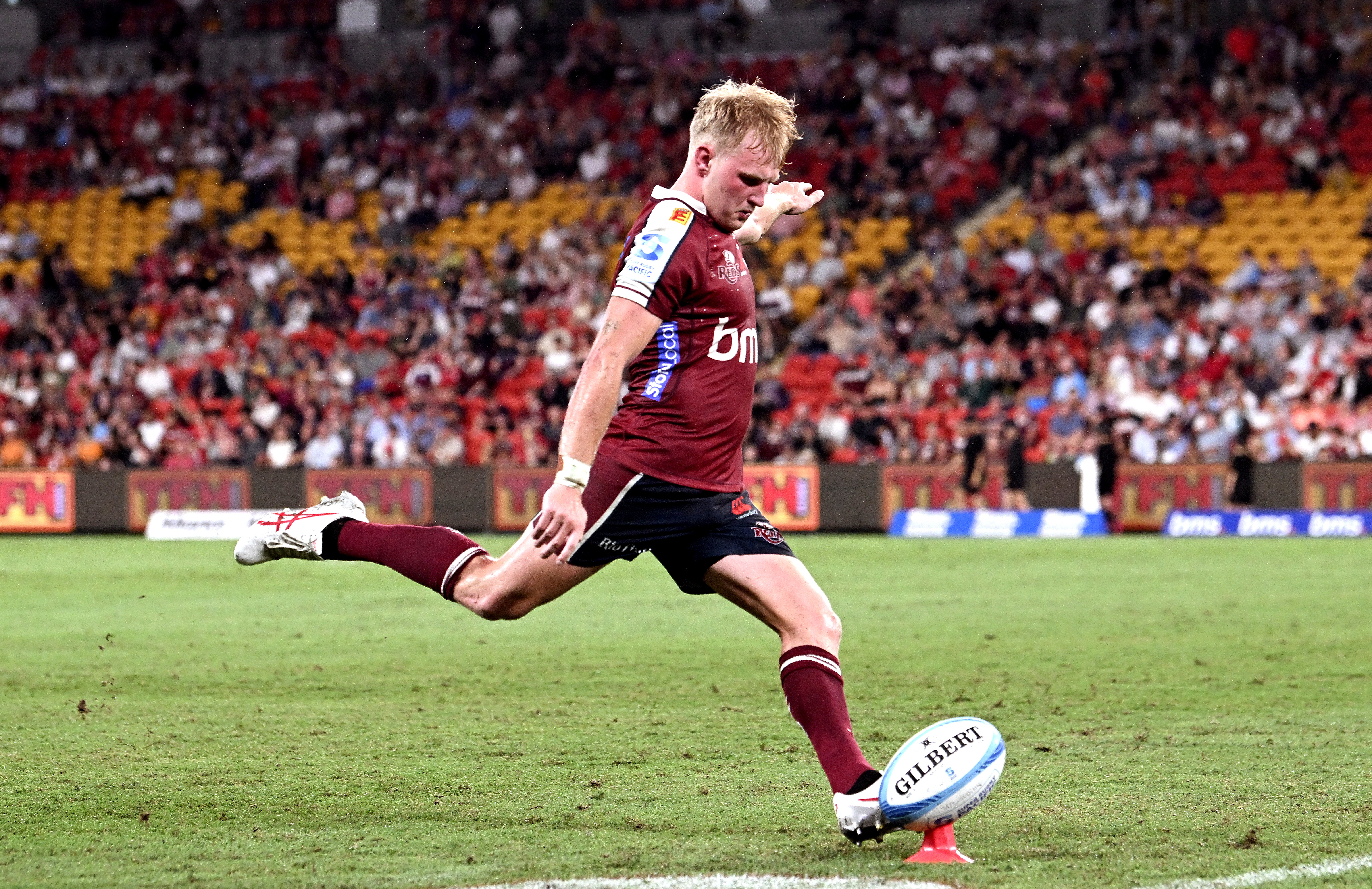 Tom Lynagh of the Reds kicks a conversion at Suncorp Stadium.