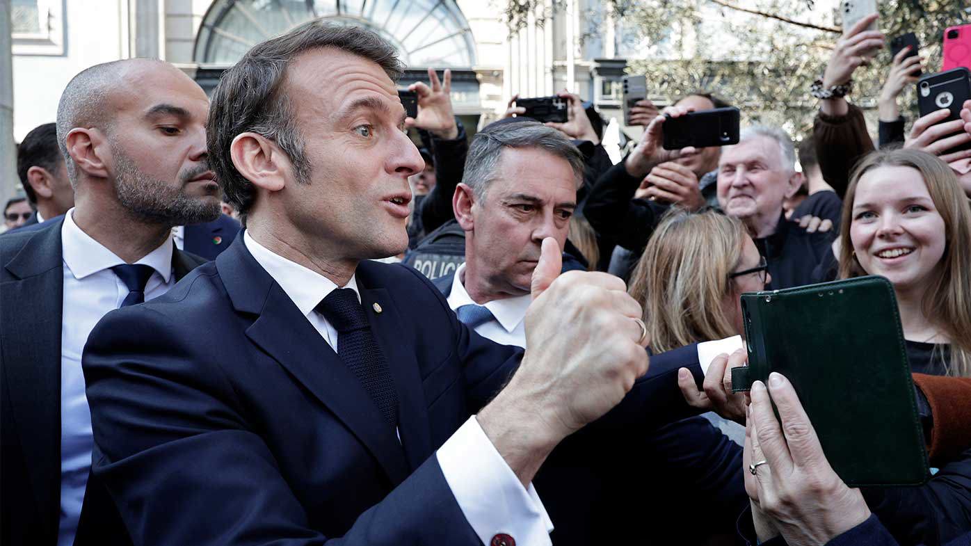 French President Emmanuel Macron greets supporters in Portugal.