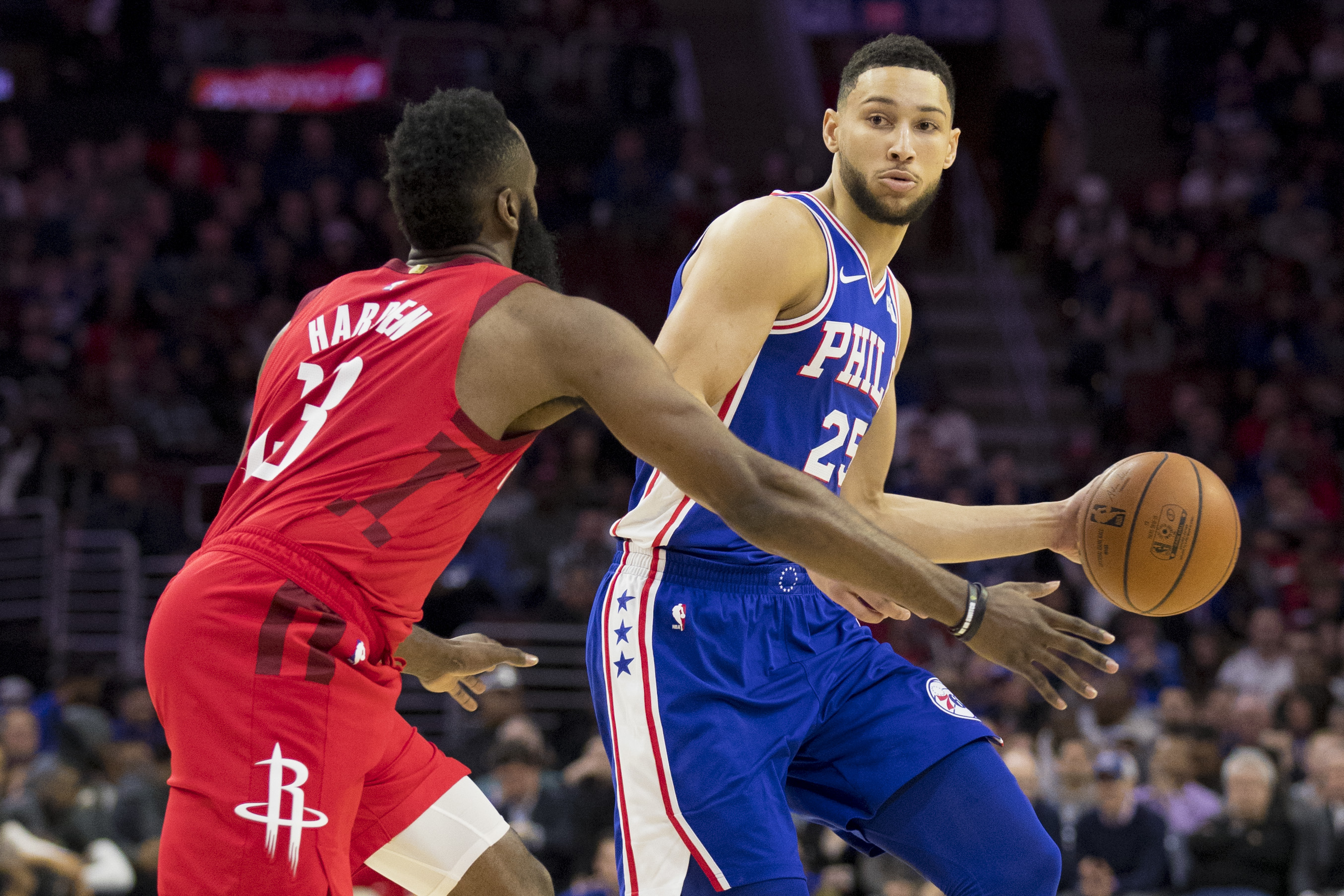 Ben Simmons dribbles the ball against James Harden.