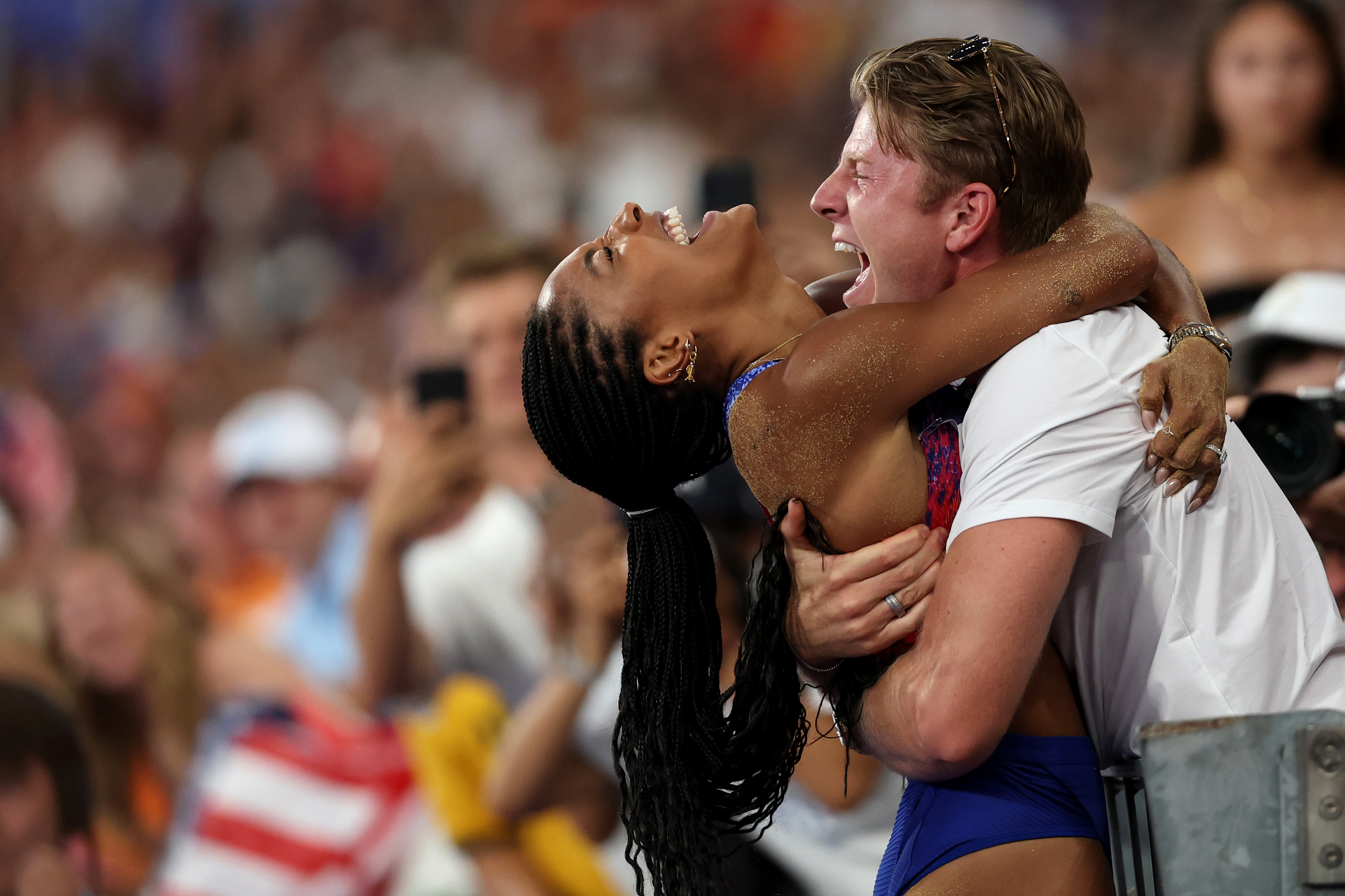 PARIS, FRANCE - AUGUST 08: Tara Davis-Woodhall of Team United States celebrates with her husband Hunter Woodhall after winning the gold medal in the Women's Long Jump Final on day thirteen of the Olympic Games Paris 2024 at Stade de France on August 08, 2024 in Paris, France. (Photo by Patrick Smith/Getty Images)