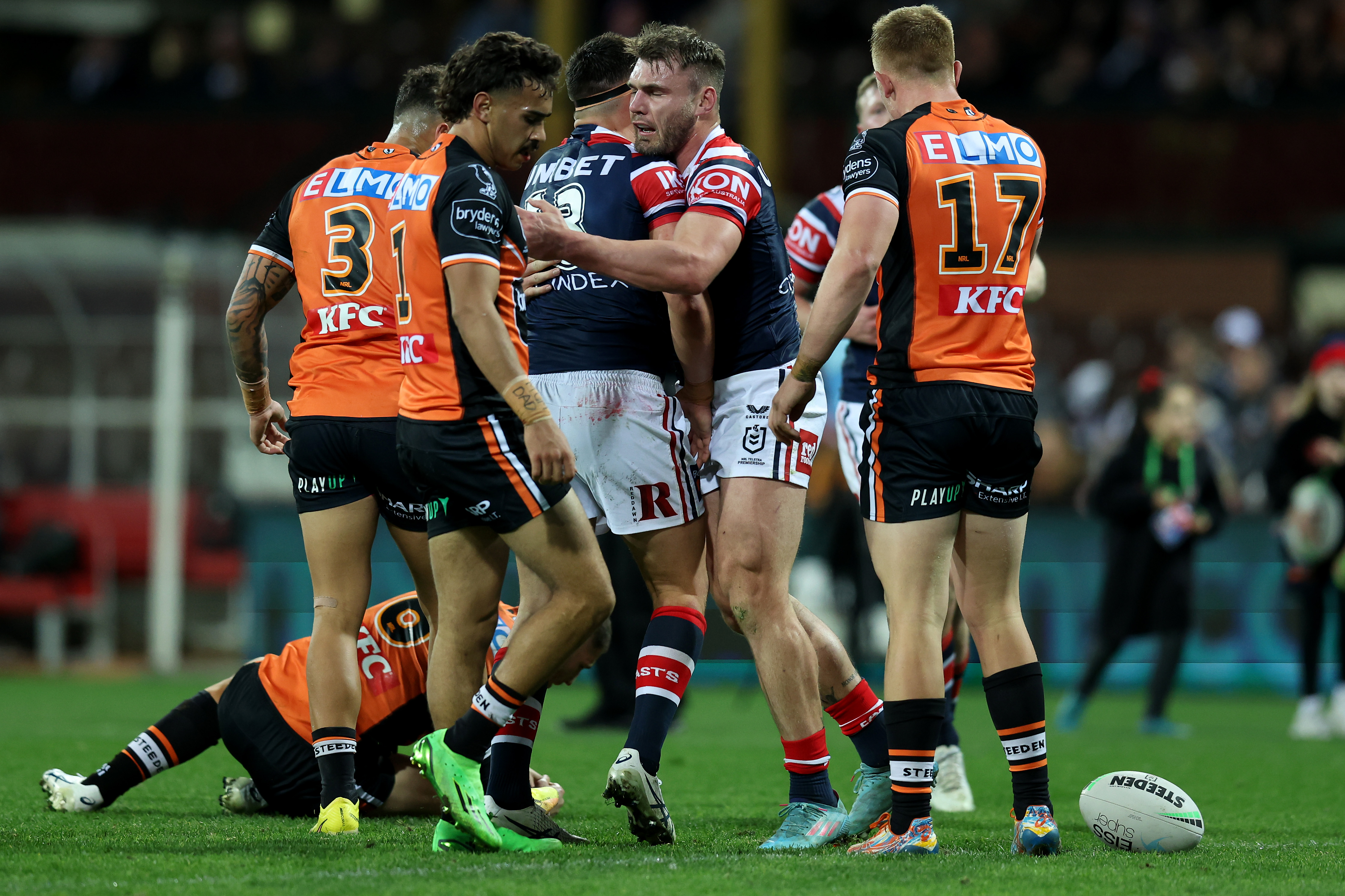 Angus Crichton of the Roosters celebrates a try as the beaten Tigers watch on.