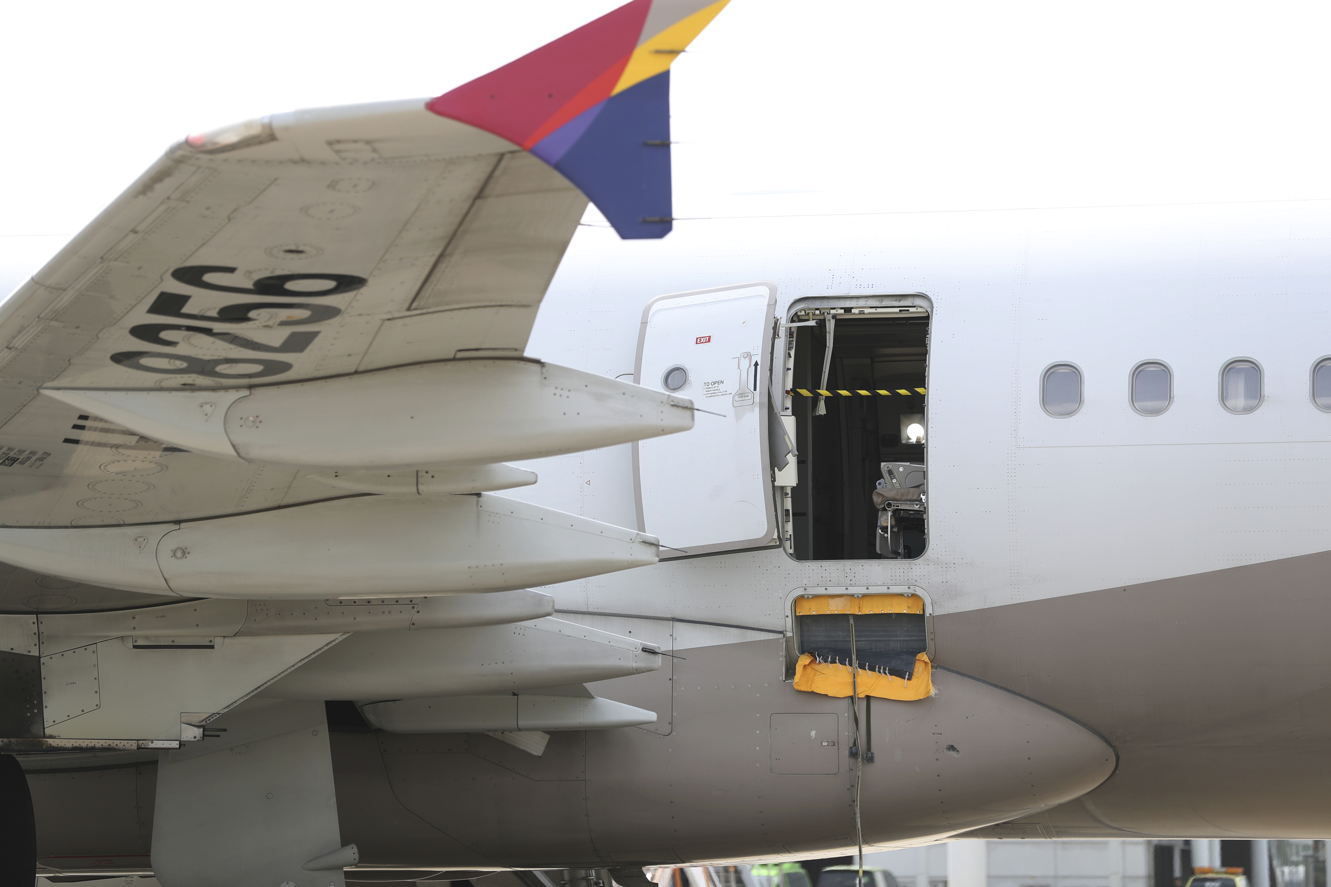 An Asiana Airlines plane is parked as one of the plane's doors suddenly opened at Daegu International Airport in Daegu, South Korea, Friday, May 26, 2023. 