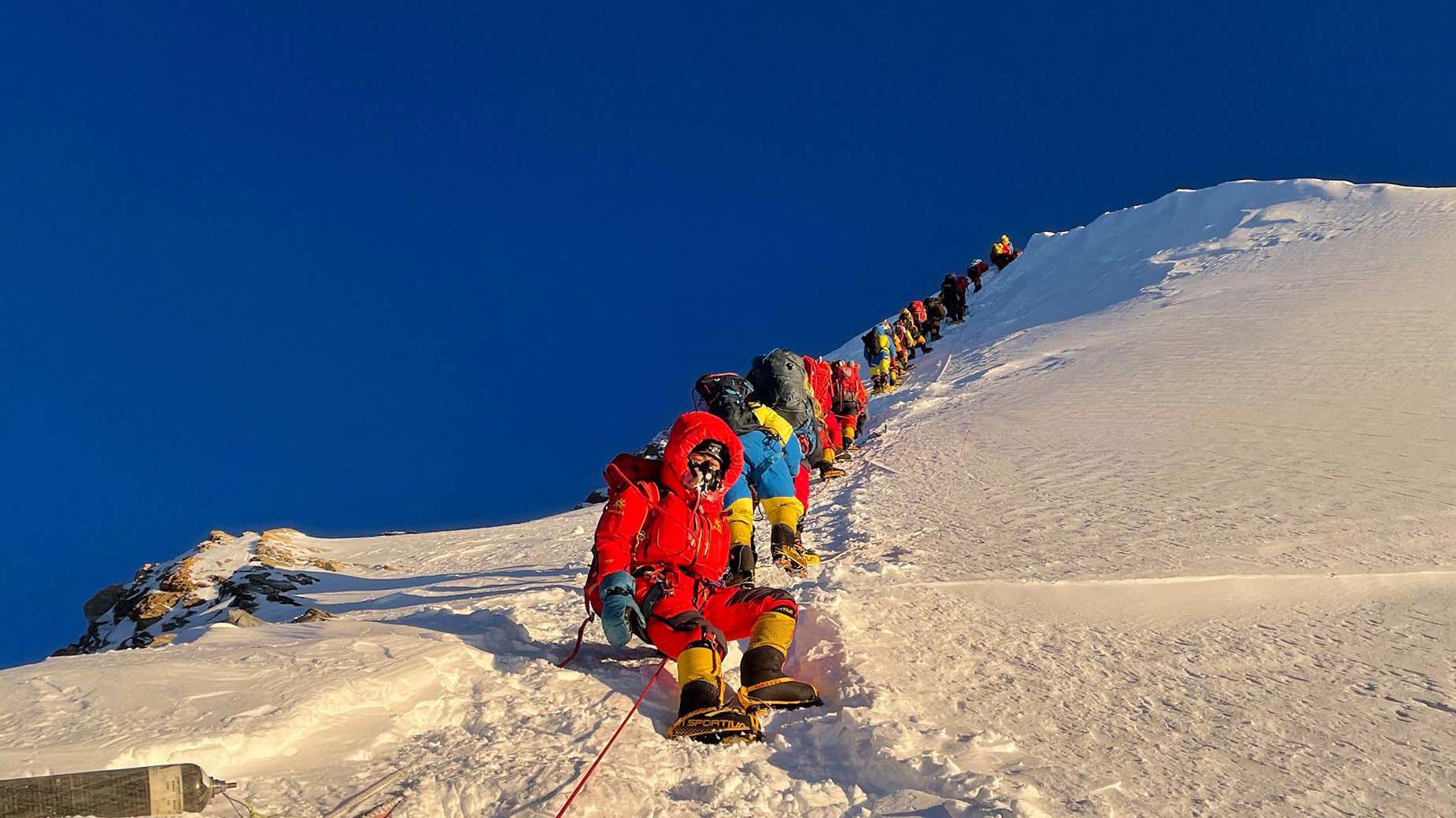  Mountaineers as they climb during their ascend to summit Mount Everest in May 2021.