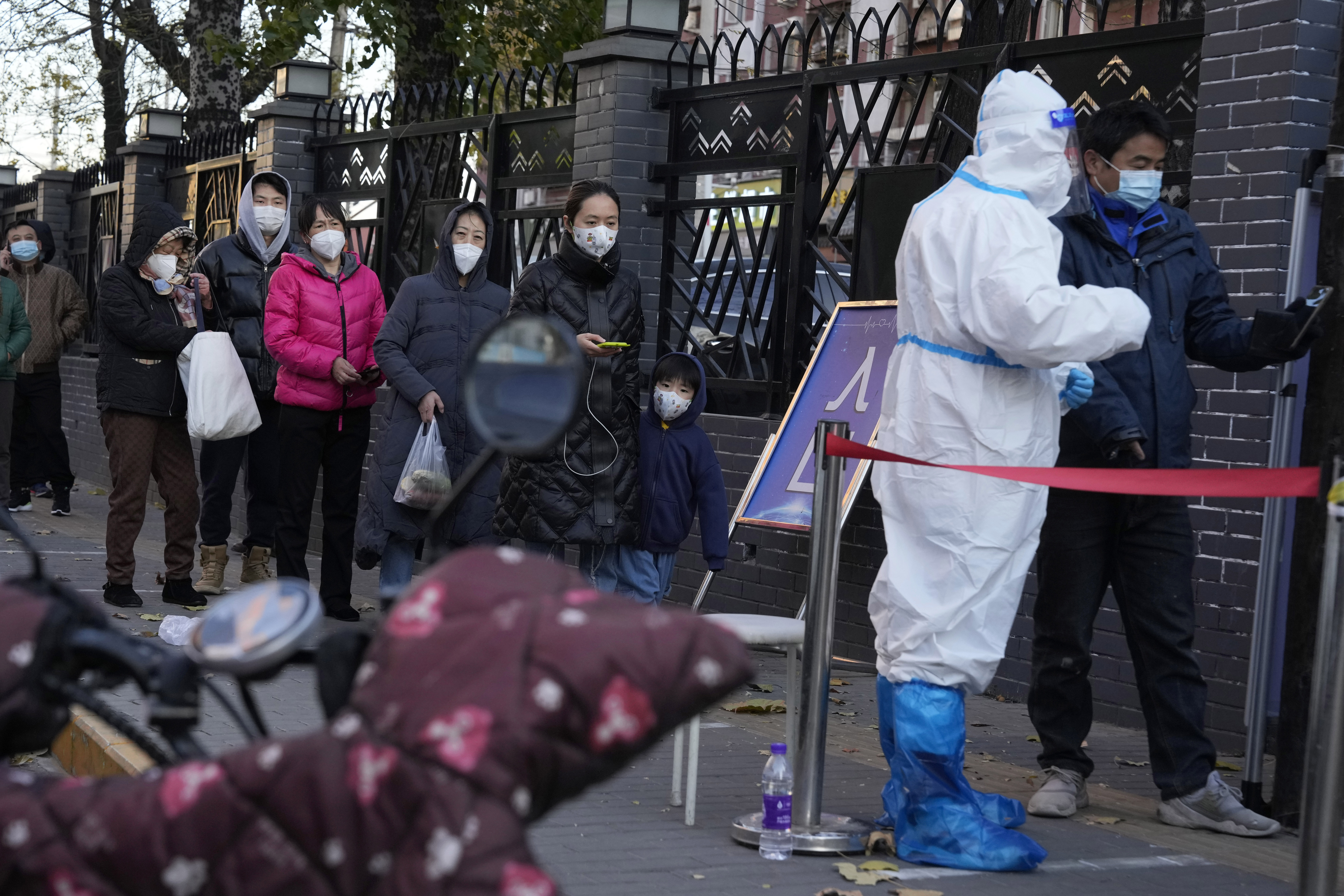 Residents line up for COVID-19 tests in Beijing, Saturday, Nov. 26, 2022. 