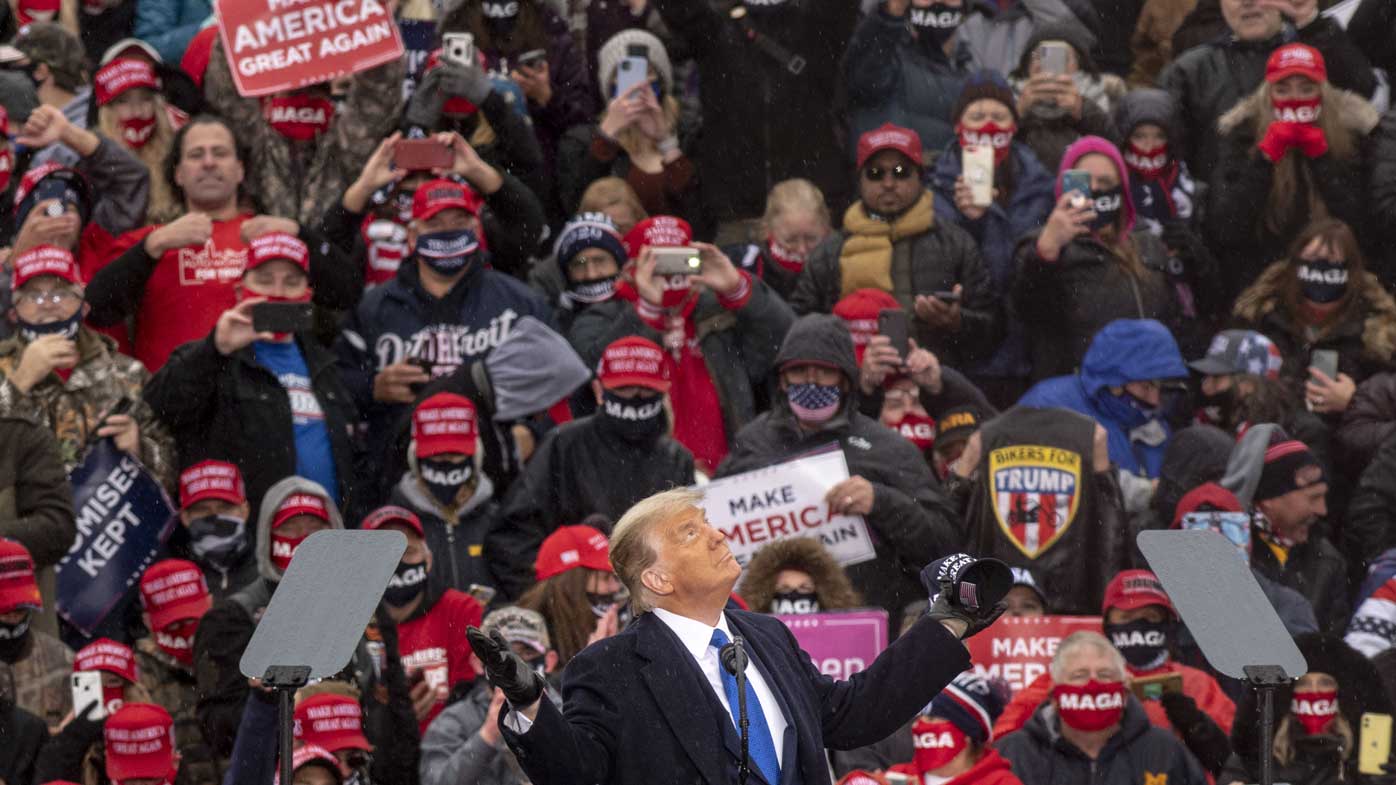 Donald Trump speaks to a crowded rally in Lansing, Michigan.