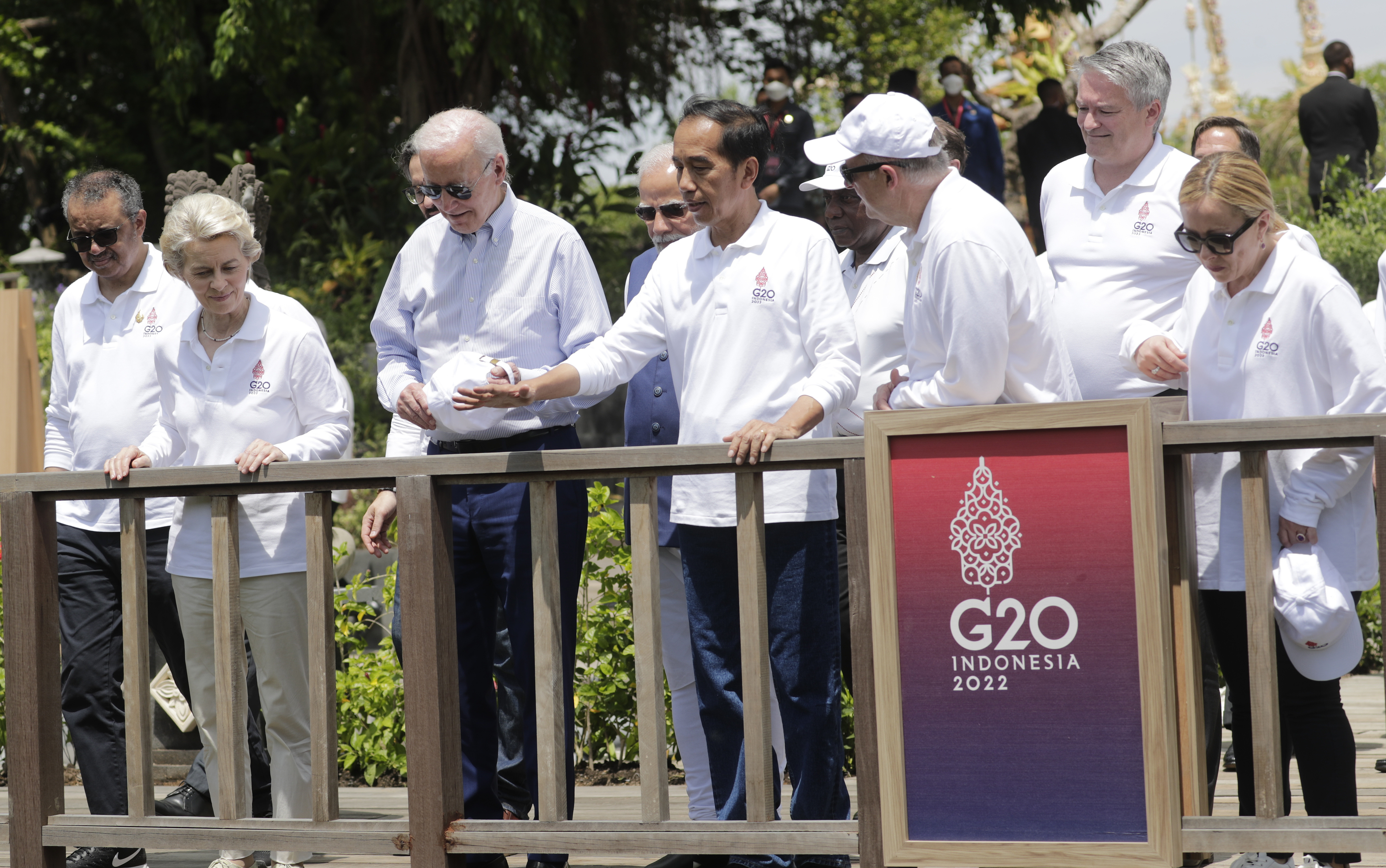 From left, World Health Organisation (WHO) Director-General Tedros Adhanom Ghebreyesus, European Commission President Ursula von der Leyen, US President Joe Biden, Indonesian President Joko Widodo, Australian Prime Minister Anthony Albanese, OECD Secretary-General Mathias Cormann and Italian Prime Minister Giorgia Meloni attend a mangrove planting event at the G20 in Bali.