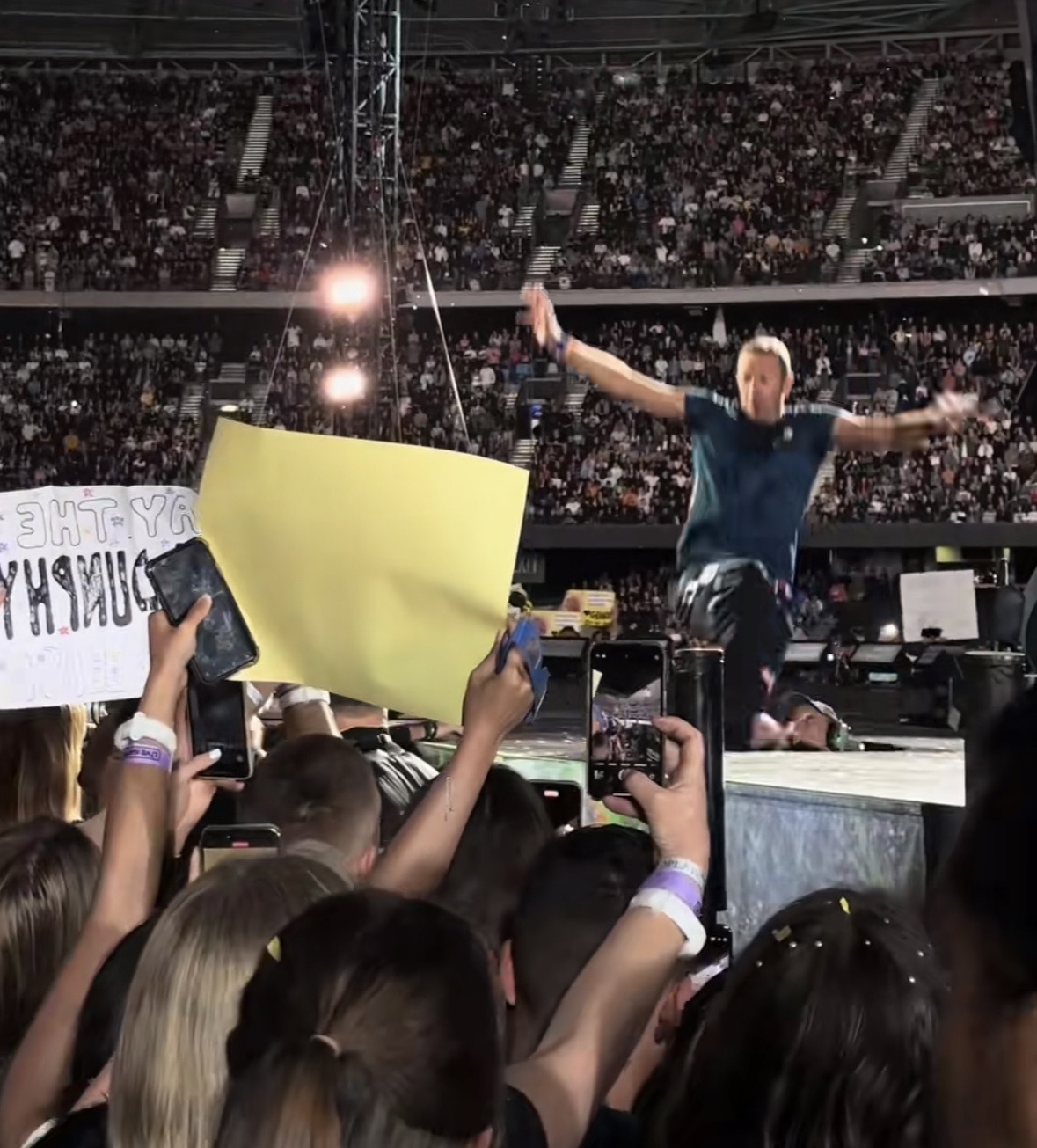 Chris Martin falls through a hole on the stage during Coldplay concert