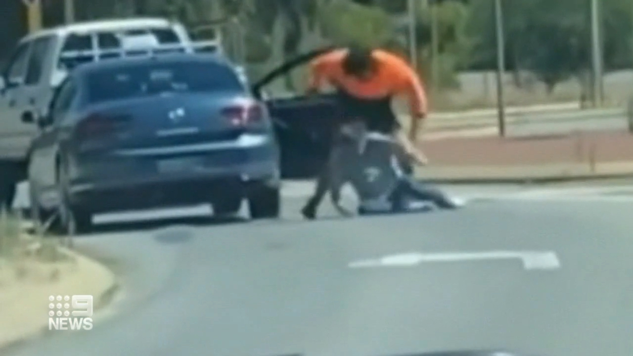 An unknown driver in a high-visibility shirt can be seen dragging the cab driver out of his car, throwing him to the ground and then punching ﻿him multiple times.