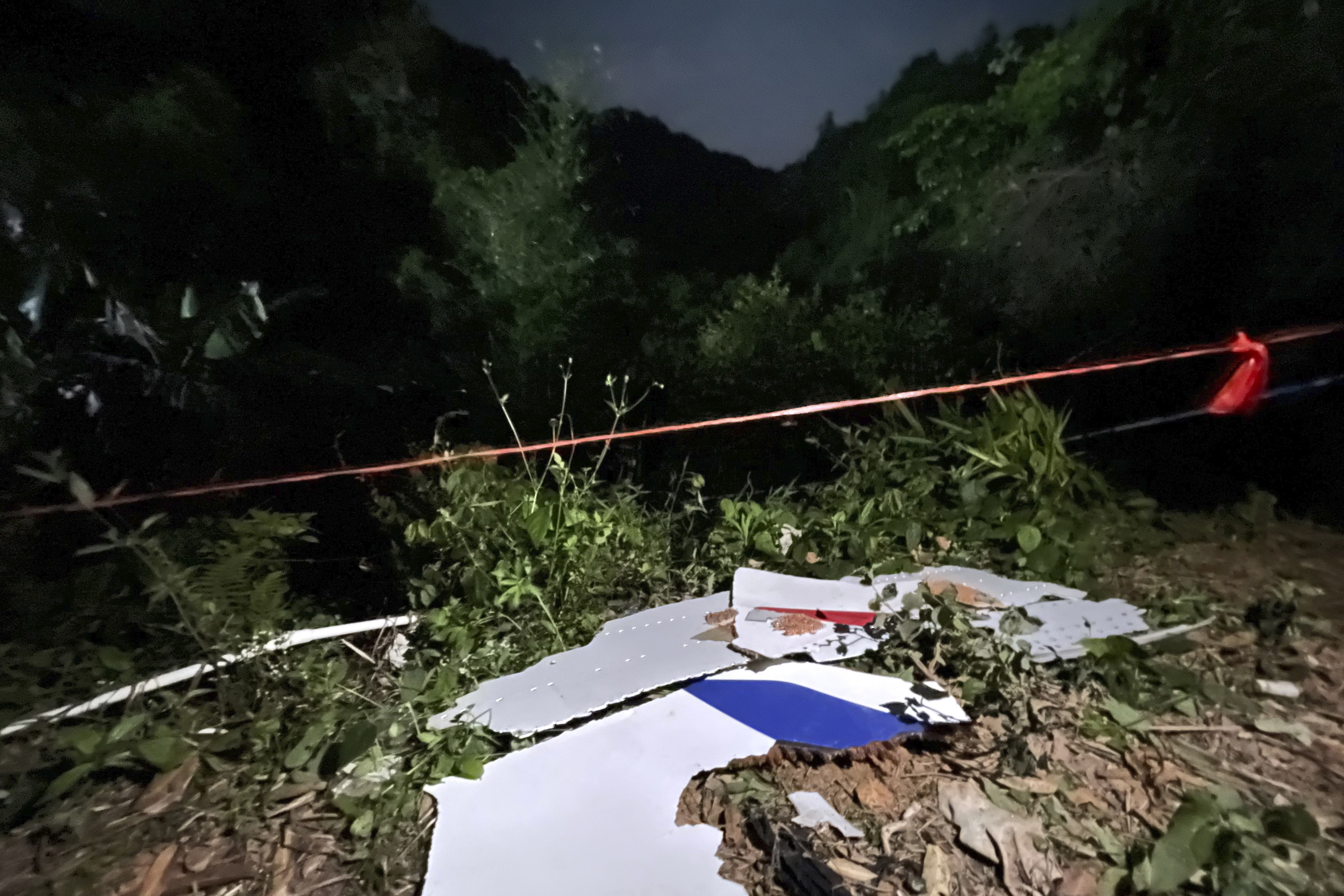 In this photo released by Chinas Xinhua News Agency, debris is seen at the site of a plane crash in Tengxian County in southern Chinas Guangxi Zhuang Autonomous Region, Tuesday, March 22, 2022. A China Eastern Boeing 737-800 with more than 100 people on board crashed in a remote mountainous area of southern China on Monday, officials said, setting off a forest fire visible from space in the countrys worst air disaster in nearly a decade. (Zhou Hua/Xinhua via AP)