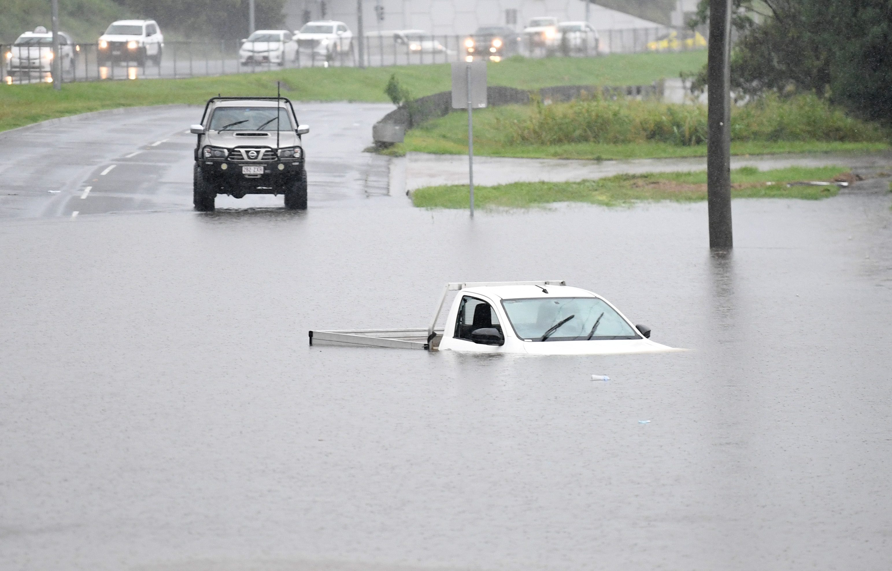 A vehicle is submerged in flood water on February 26, 2022 in the suburb of Oxley in Brisbane, Australia.