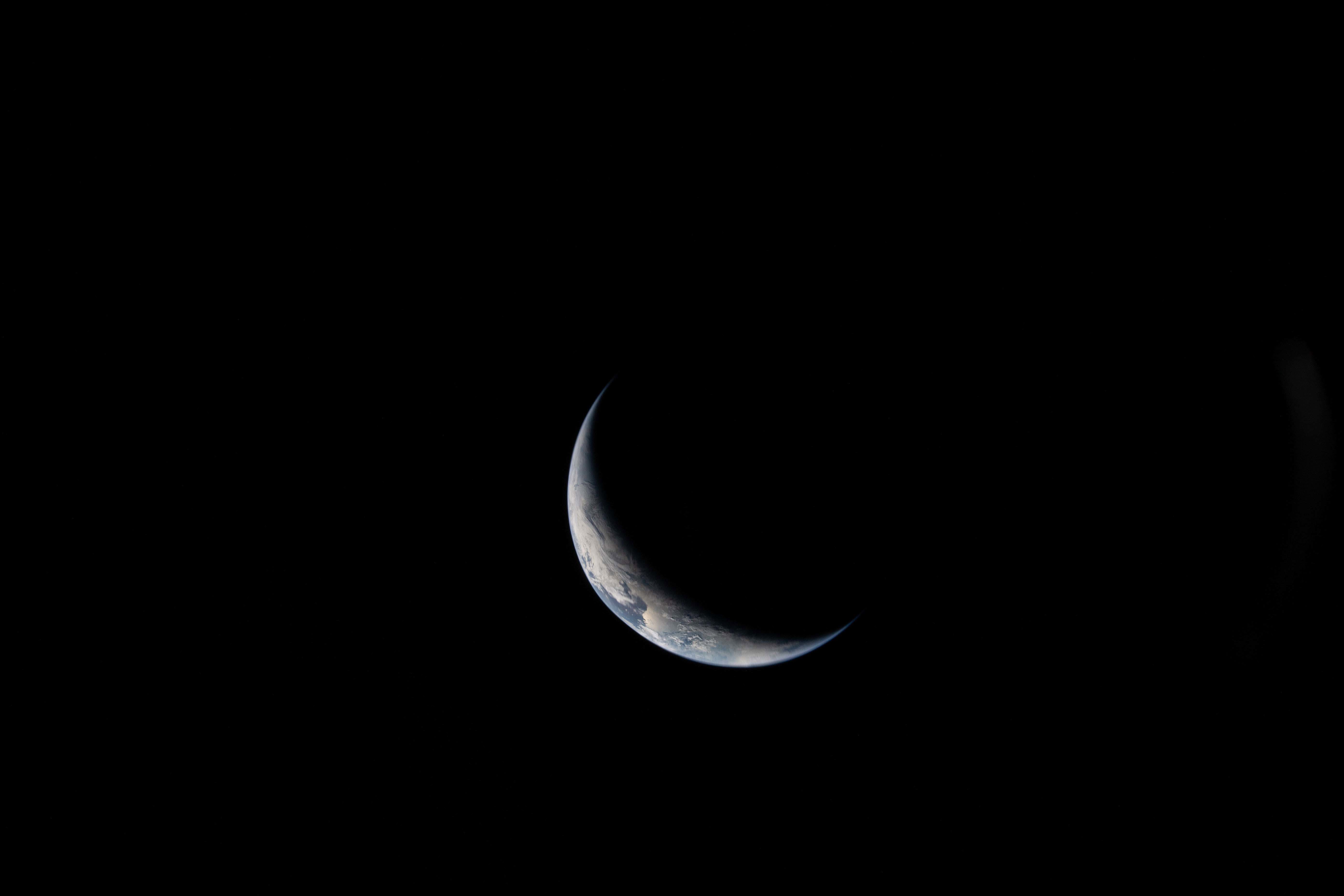 This photo provided by NASA shows the Earth seen from a window on the Orion spacecraft Integrity during the Artemis II mission en route to the moon on Friday, April 3, 2026. (NASA via AP)