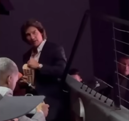 Tom Cruise eating popcorn