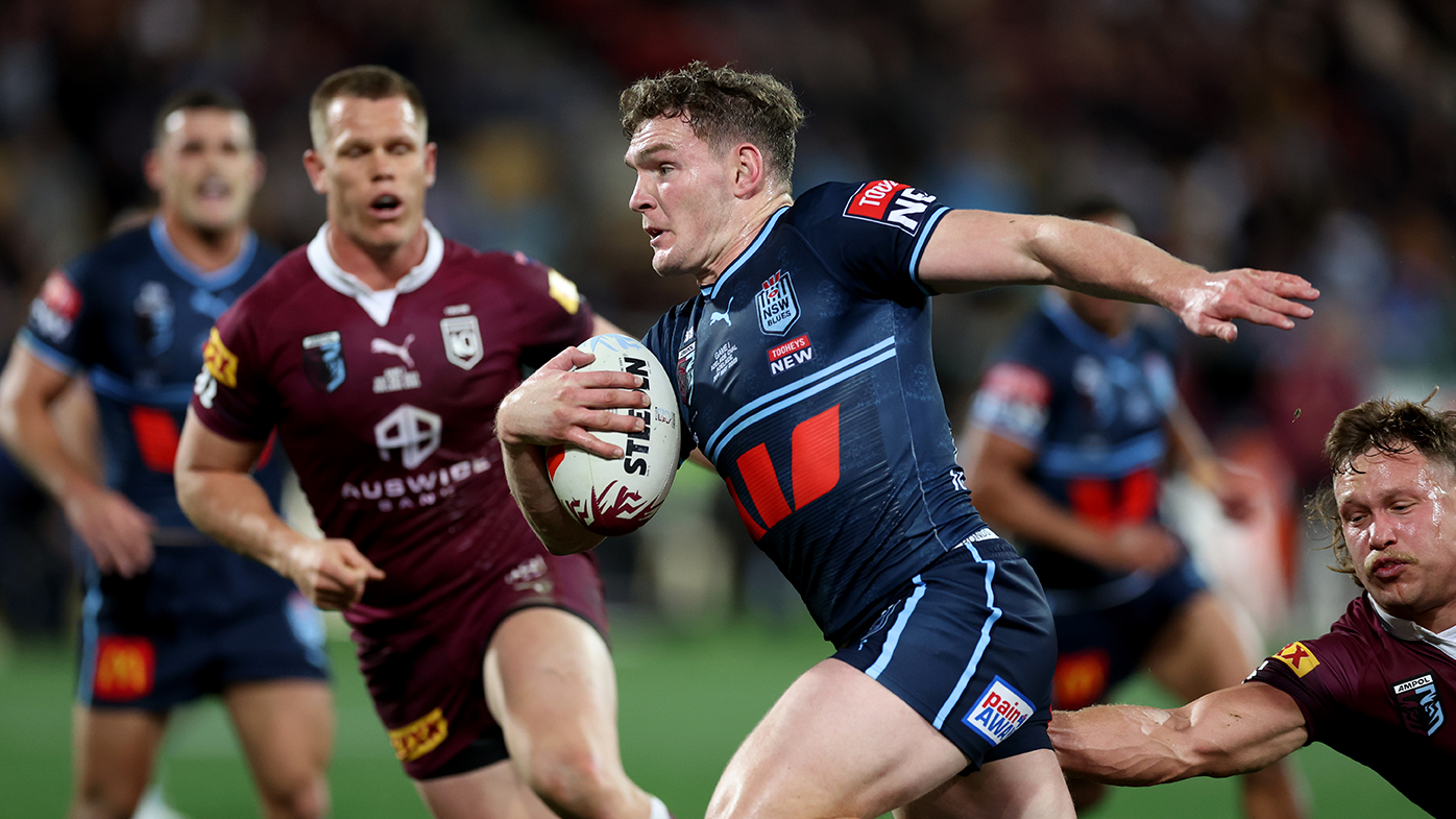 Liam Martin of the Blues runs in to score a try.
