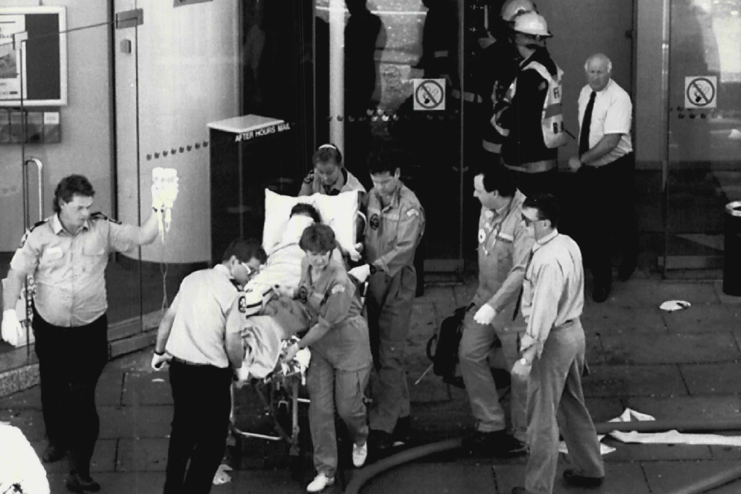 Ambulance officers rush a victim from the NCA's Adelaide headquarters after the parcel bomb explosion in 1994. 