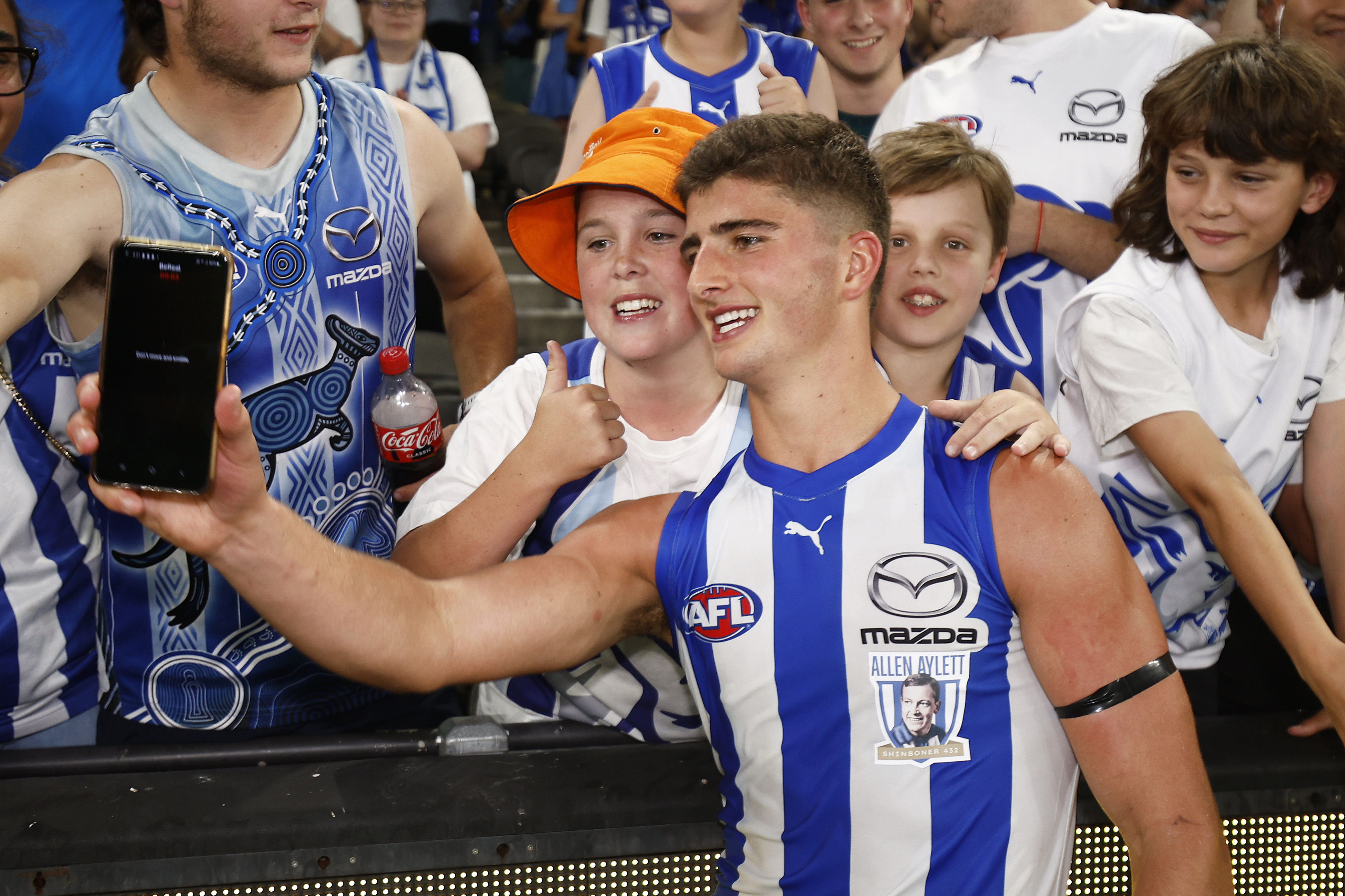 Harry Sheezel of the Kangaroos celebrates with fans after winning round one.