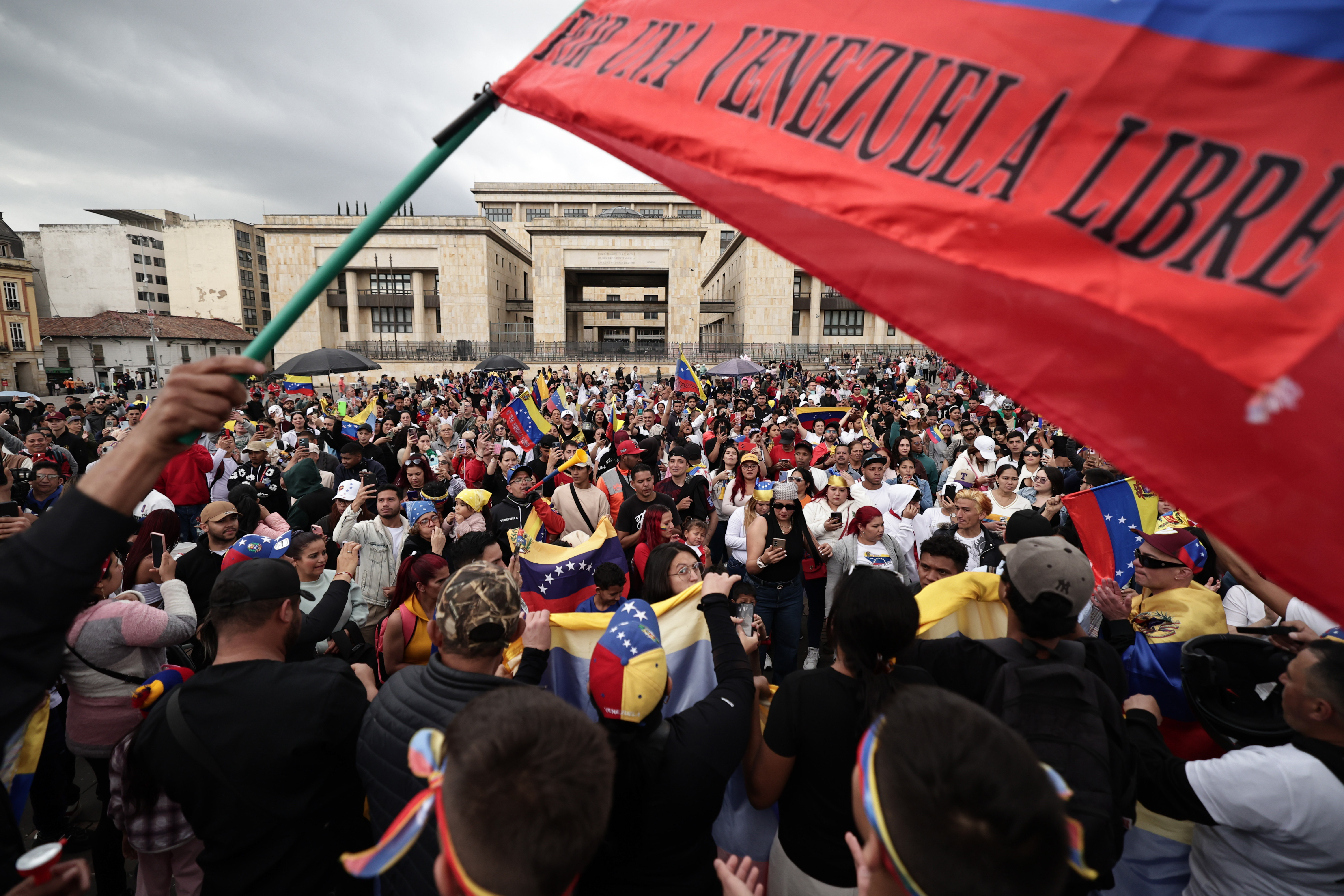 Venezuelans celebrate in Bogotá, Colombia, Saturday, Jan. 3, 2026, after U.S. President Donald Trump announced that U.S. forces had captured Venezuelan President Nicolás Maduro. (AP Photo/Jose Vargas)