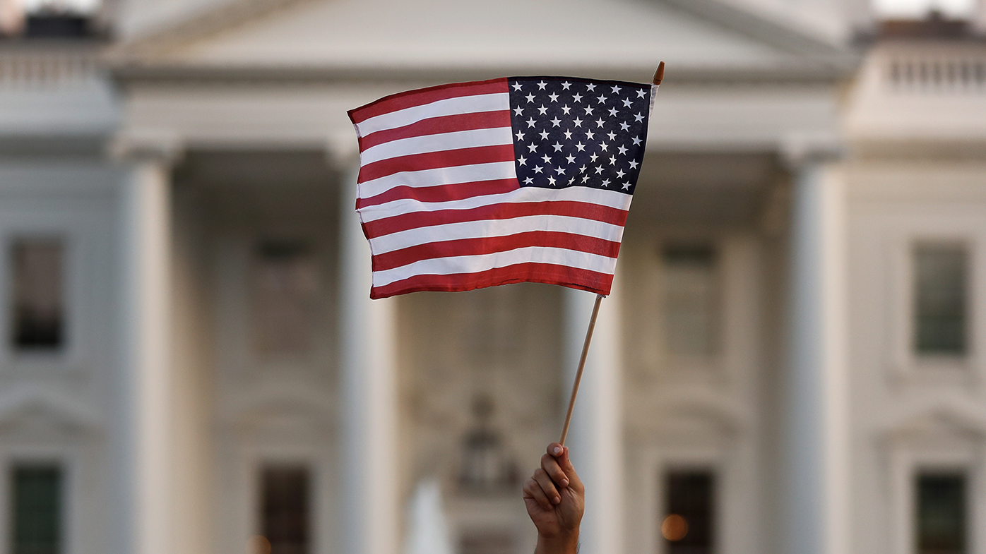 File photo: An American flag is waved during a rally outside the White House, in Washington, Monday, Sept. 4, 2017. (AP Photo/Carolyn Kaster)