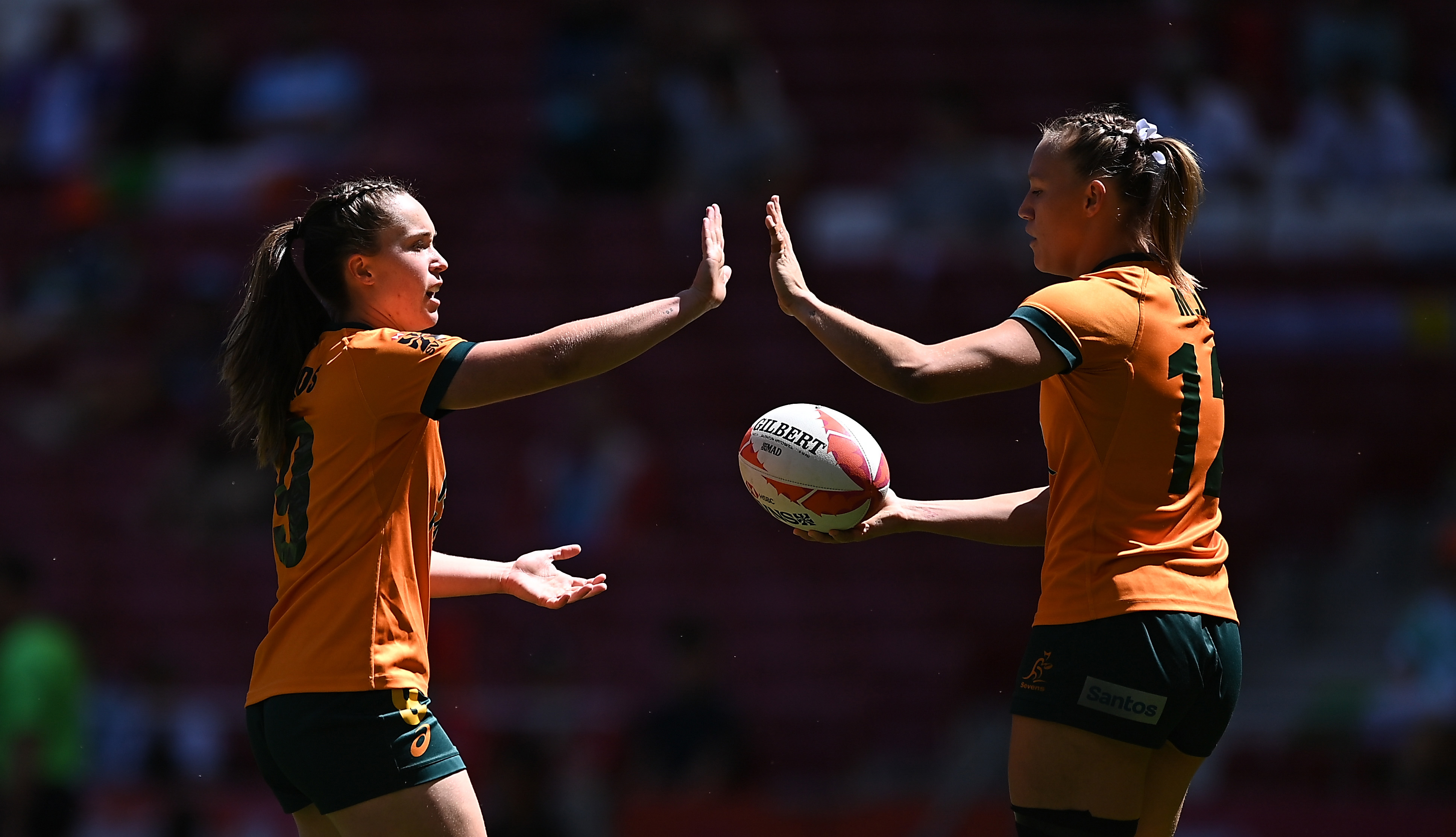 Tia Hinds of Australia congratulates Maddison Levi after she scored a try.