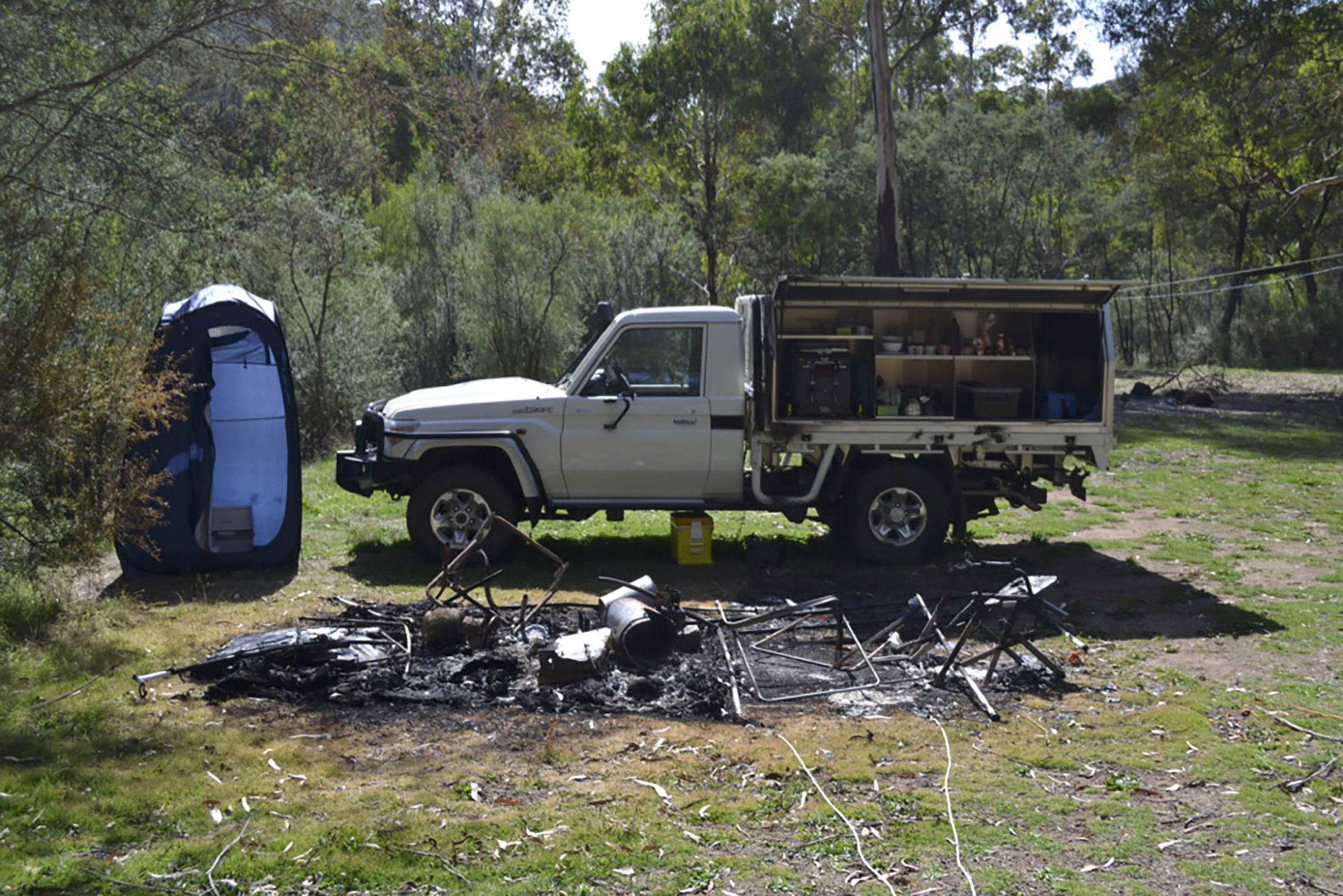 Tendered photos of Russell Hill and Carol Clay's burnt-out campsite were shown to the jury.